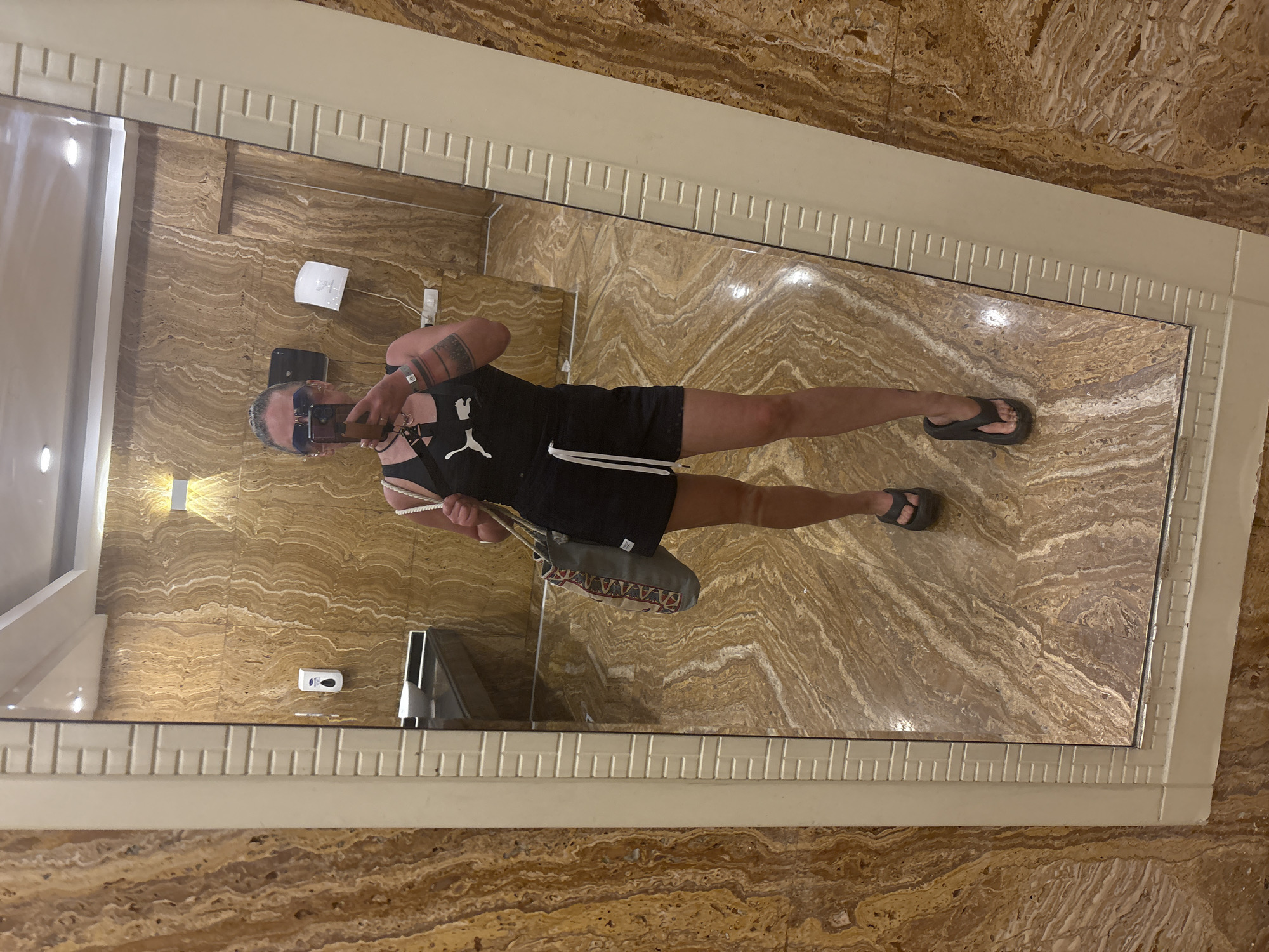 Person in black tank top seen in bathroom mirror, Egypt