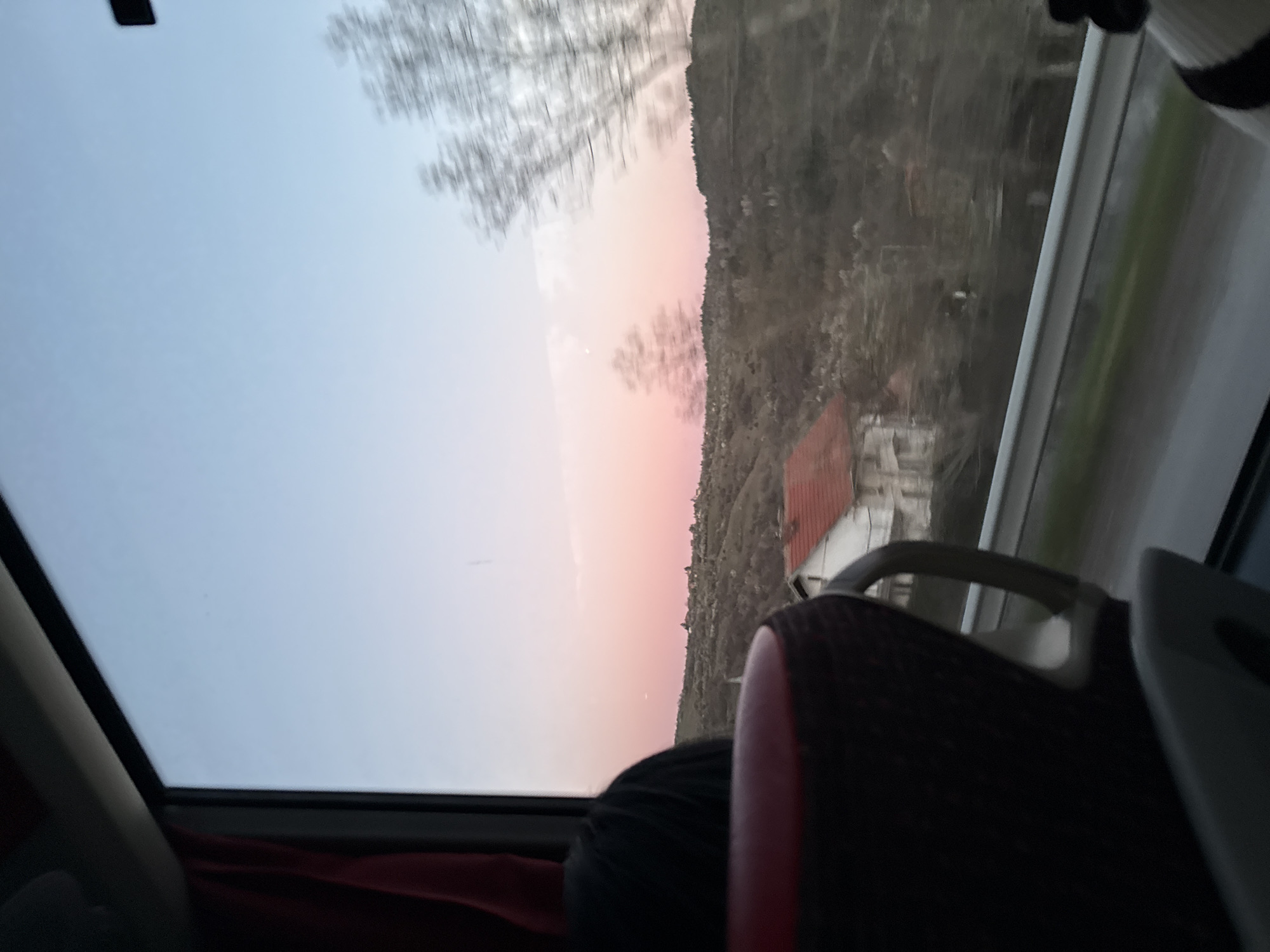 Traveler documents Bulgarian hillside landscape from moving vehicle