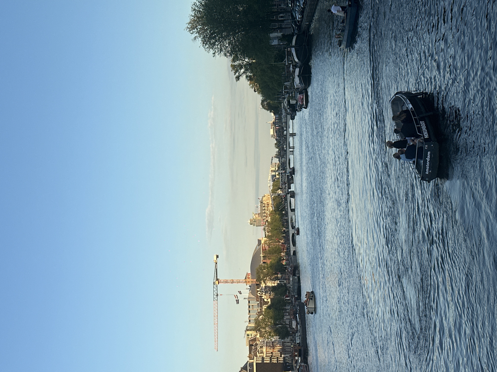 Golden hour on Amsterdam's canals, police activity nearby