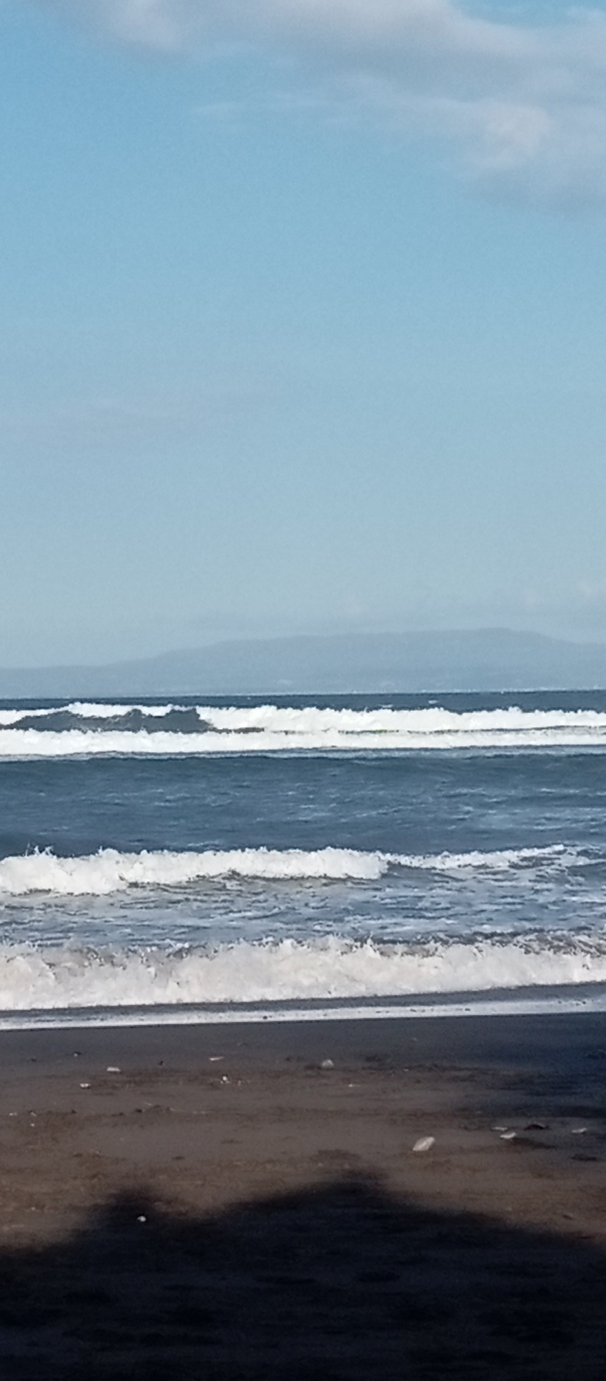 Black sand beach in Blahbatuh, kites and groups on shore
