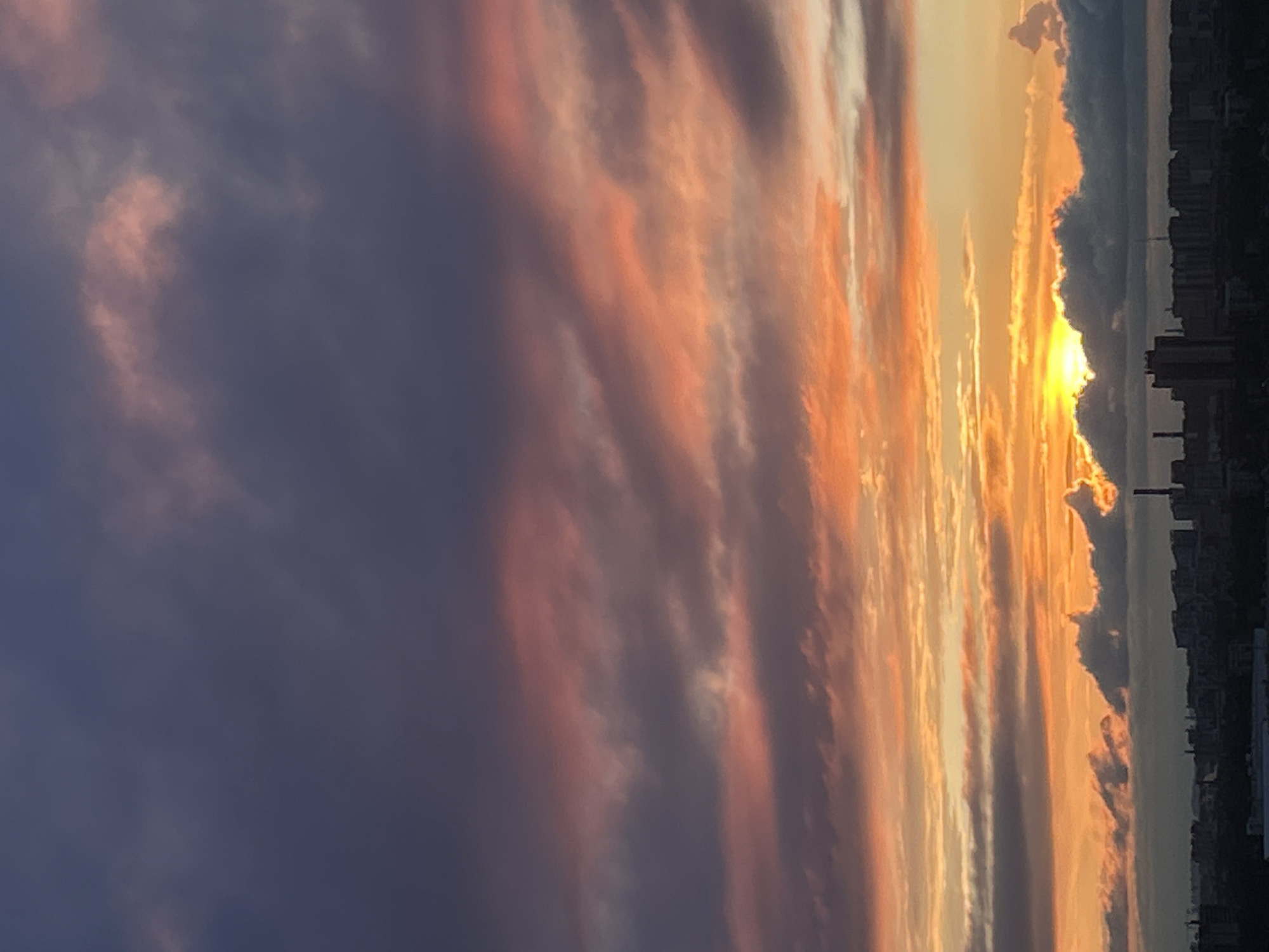 City skyline sunset with vivid cloud layers