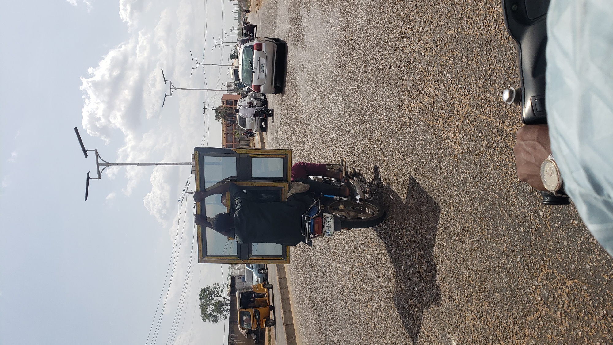 Motorcyclist carries large window frame on Nigerian road