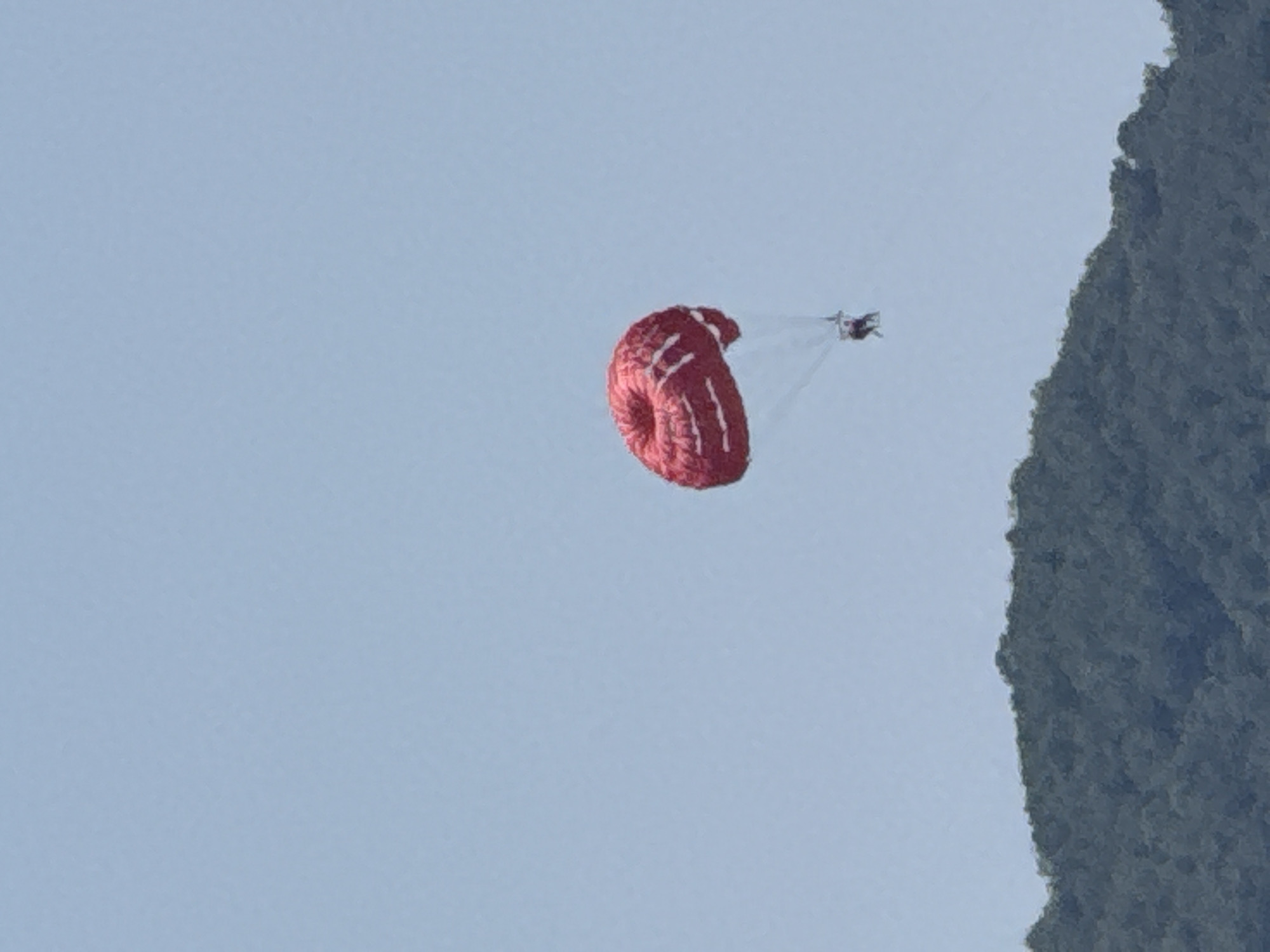 Parasailing and paragliding over Rafailovići on a clear summer day