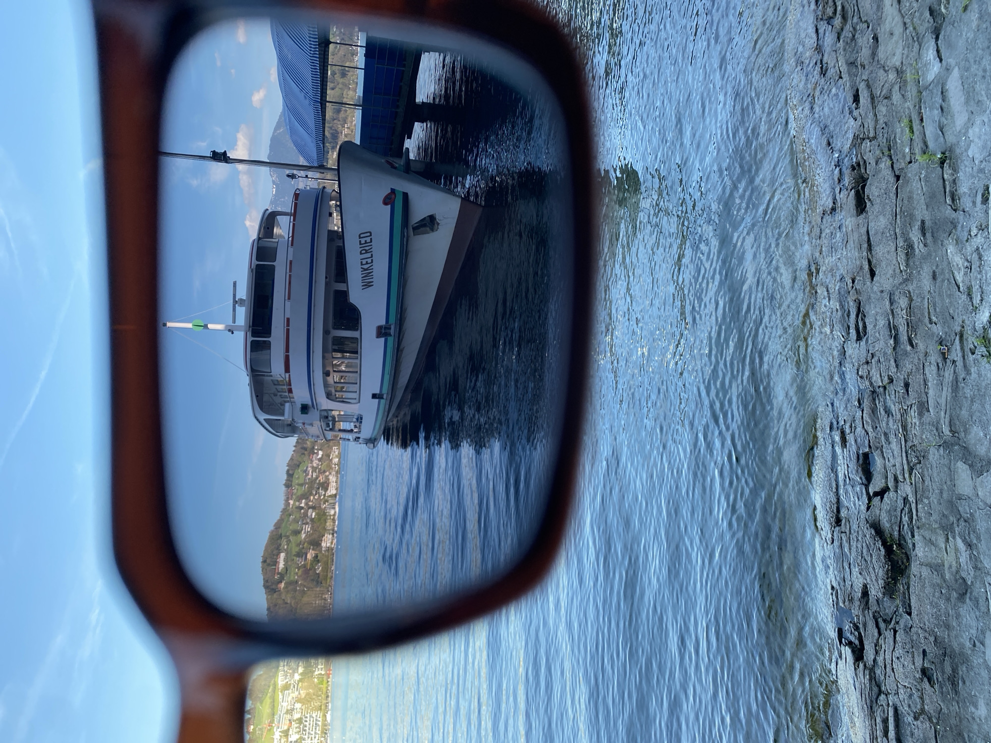 Boat 'Winkelried' docked at Lucerne pier viewed through sunglasses