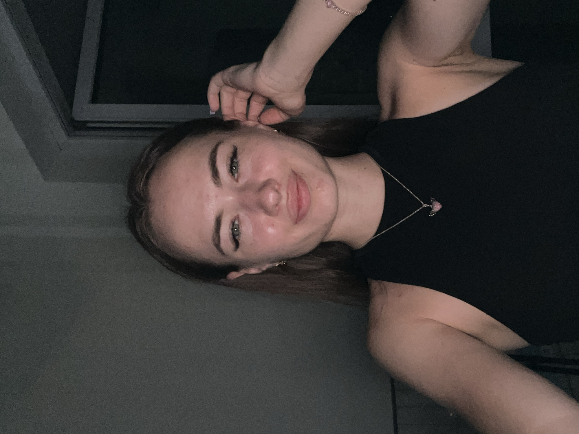 Indoor selfie session, black top and pink heart necklace