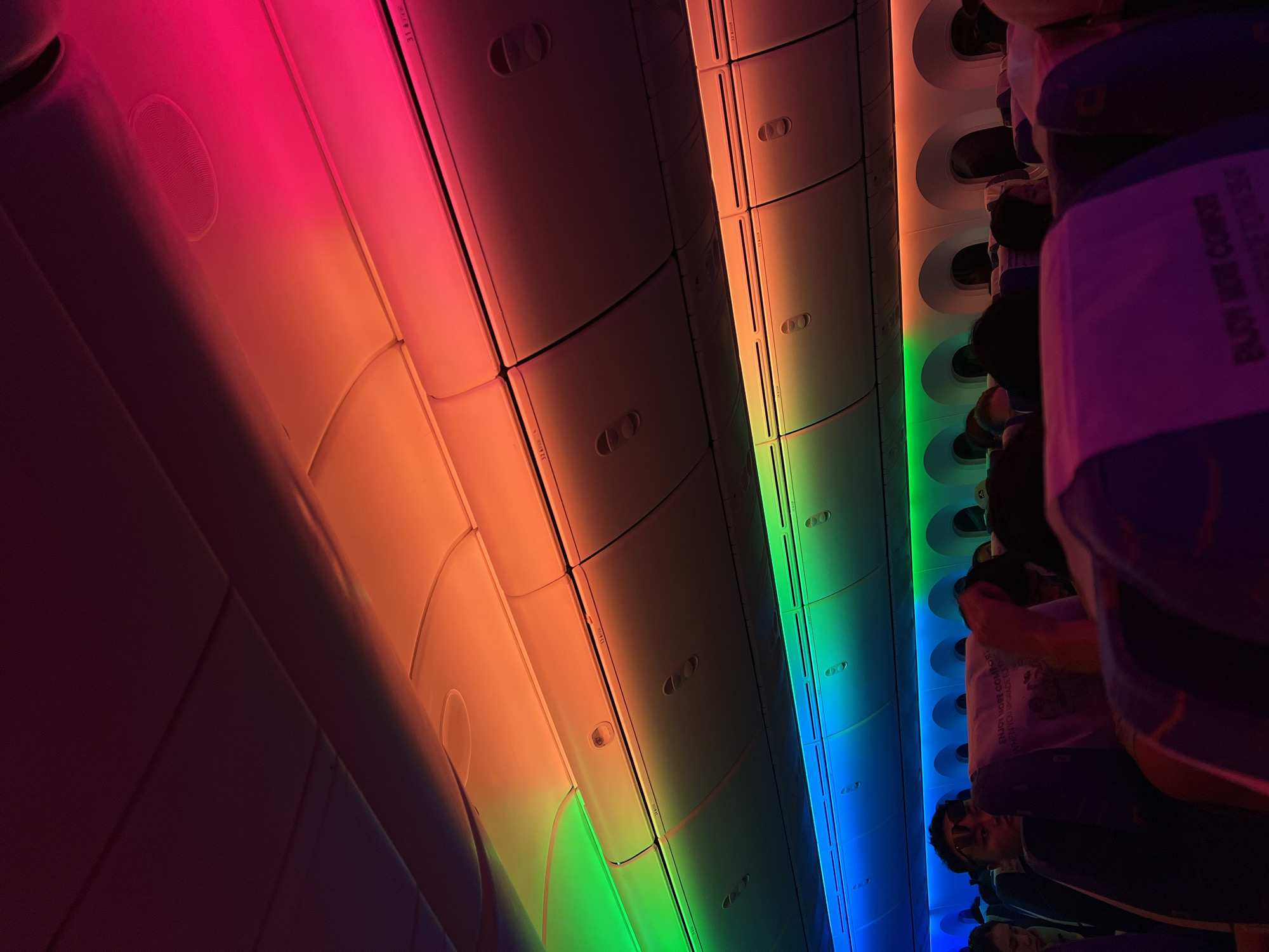 Rainbow LED lighting fills an airplane cabin at night
