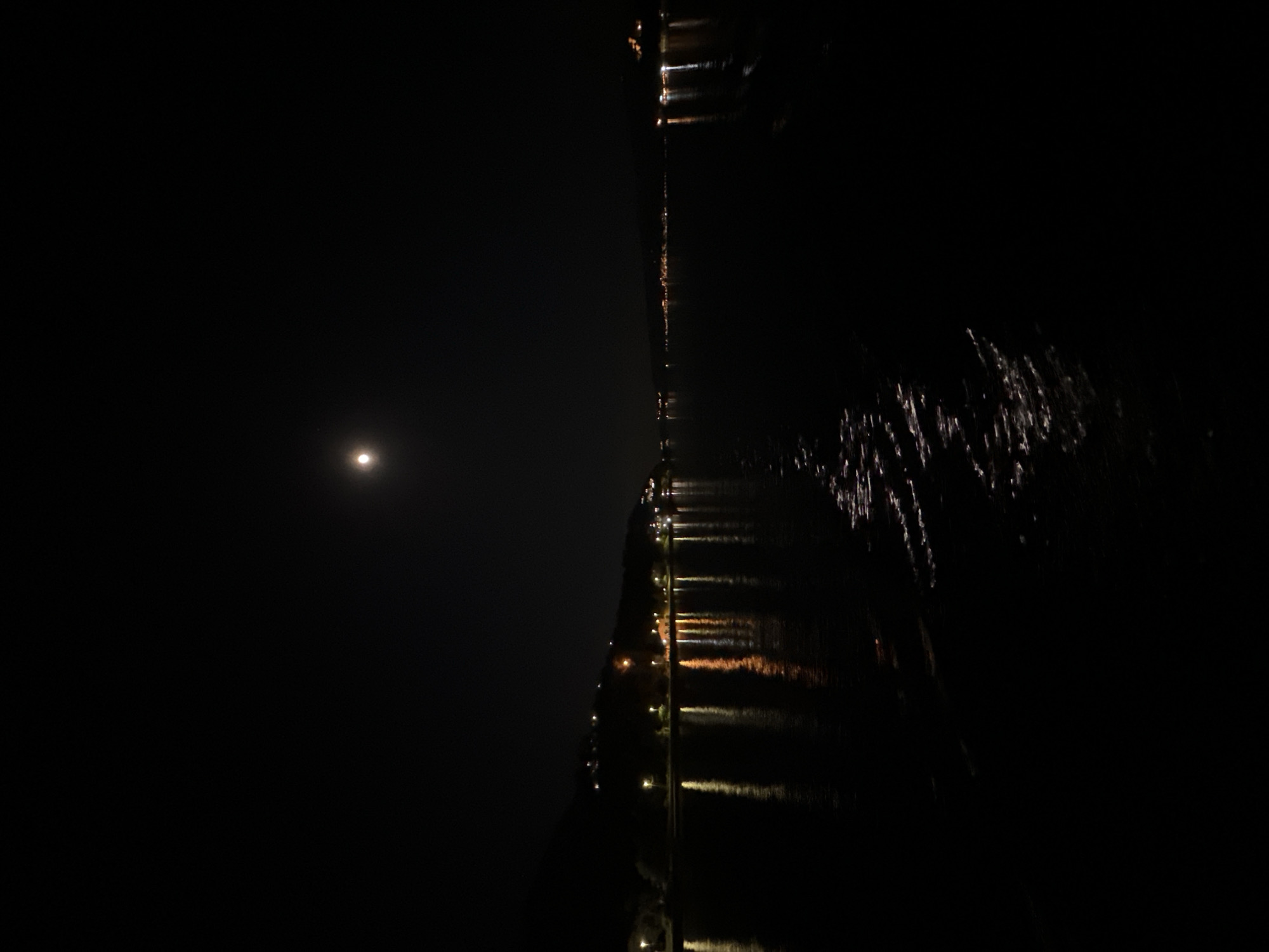 Ferry crossing captured under moonlight between Montenegro coastal towns