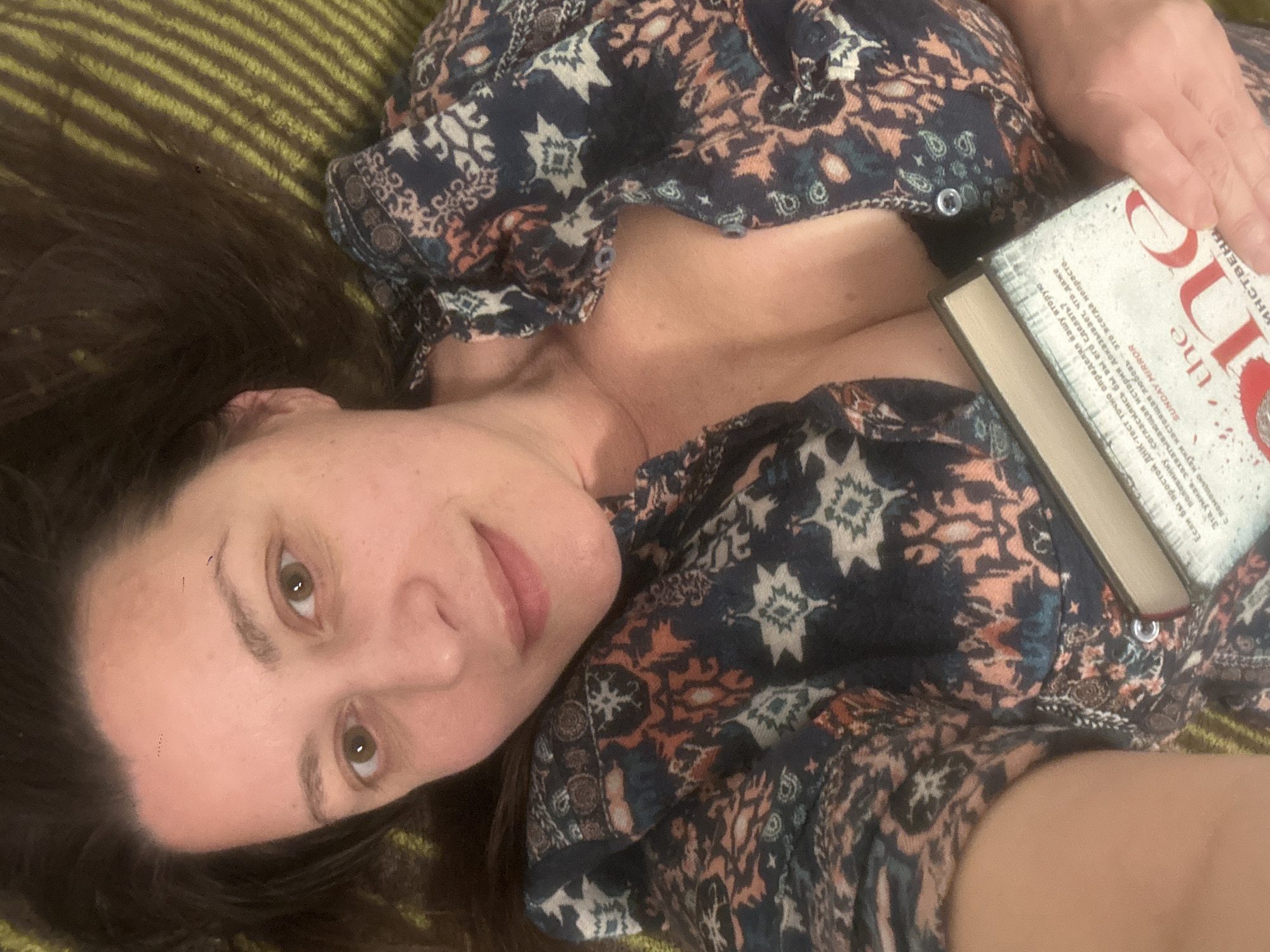 Reader examines seashells while enjoying book in Riga