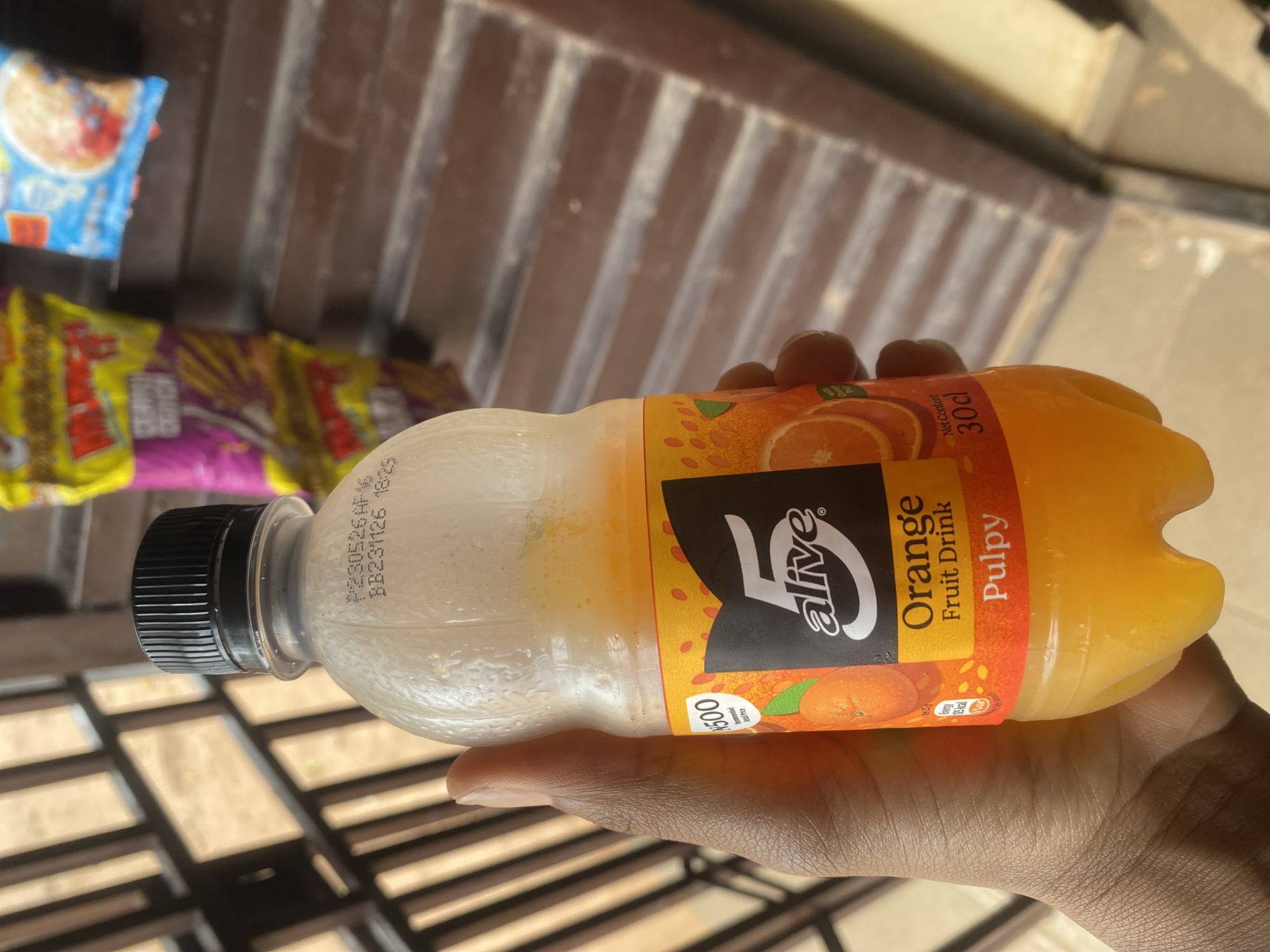 A drink in hand and a cloudy sky in Lafia, Nigeria