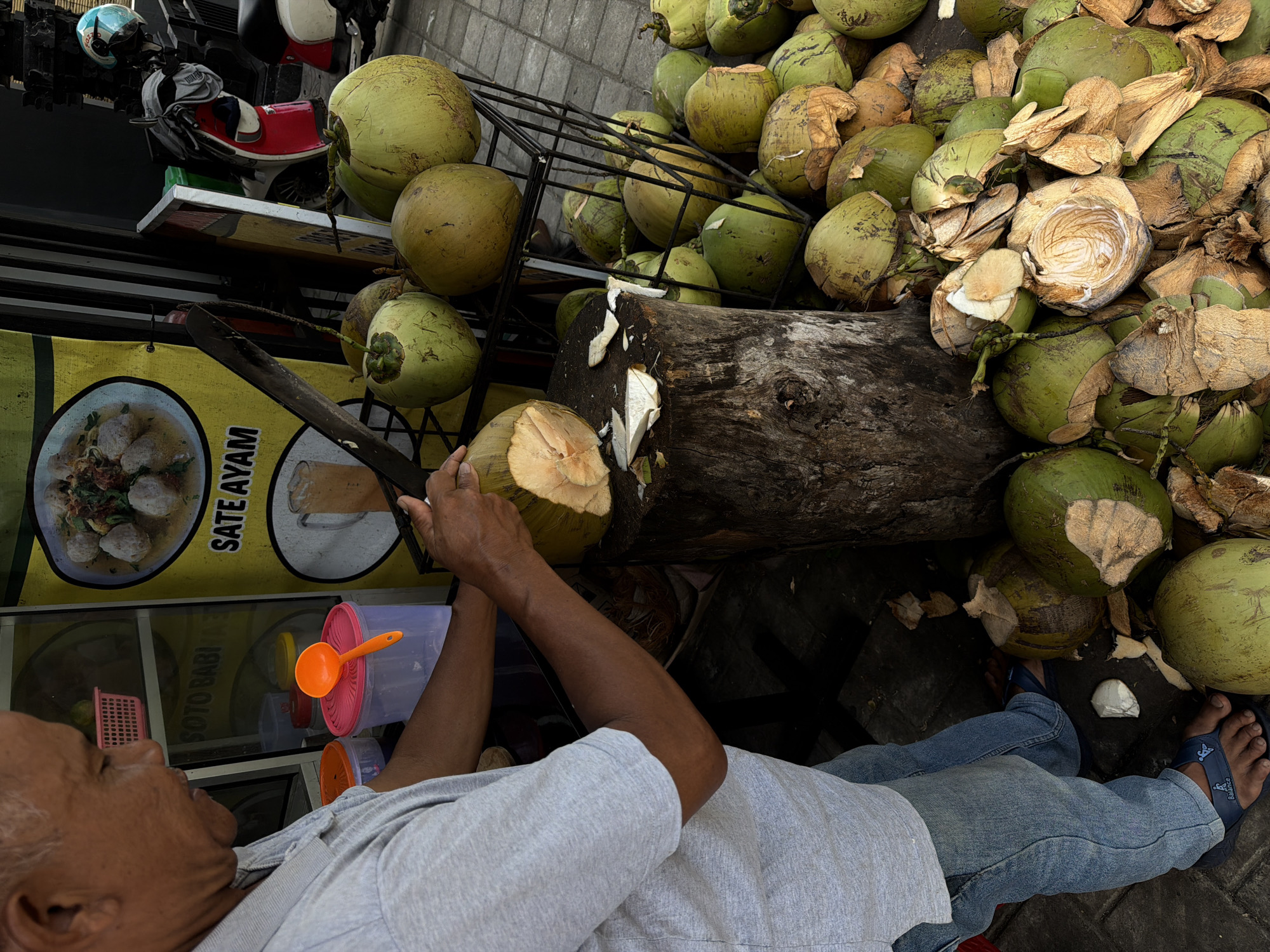 Man prepares coconut in Indonesian village