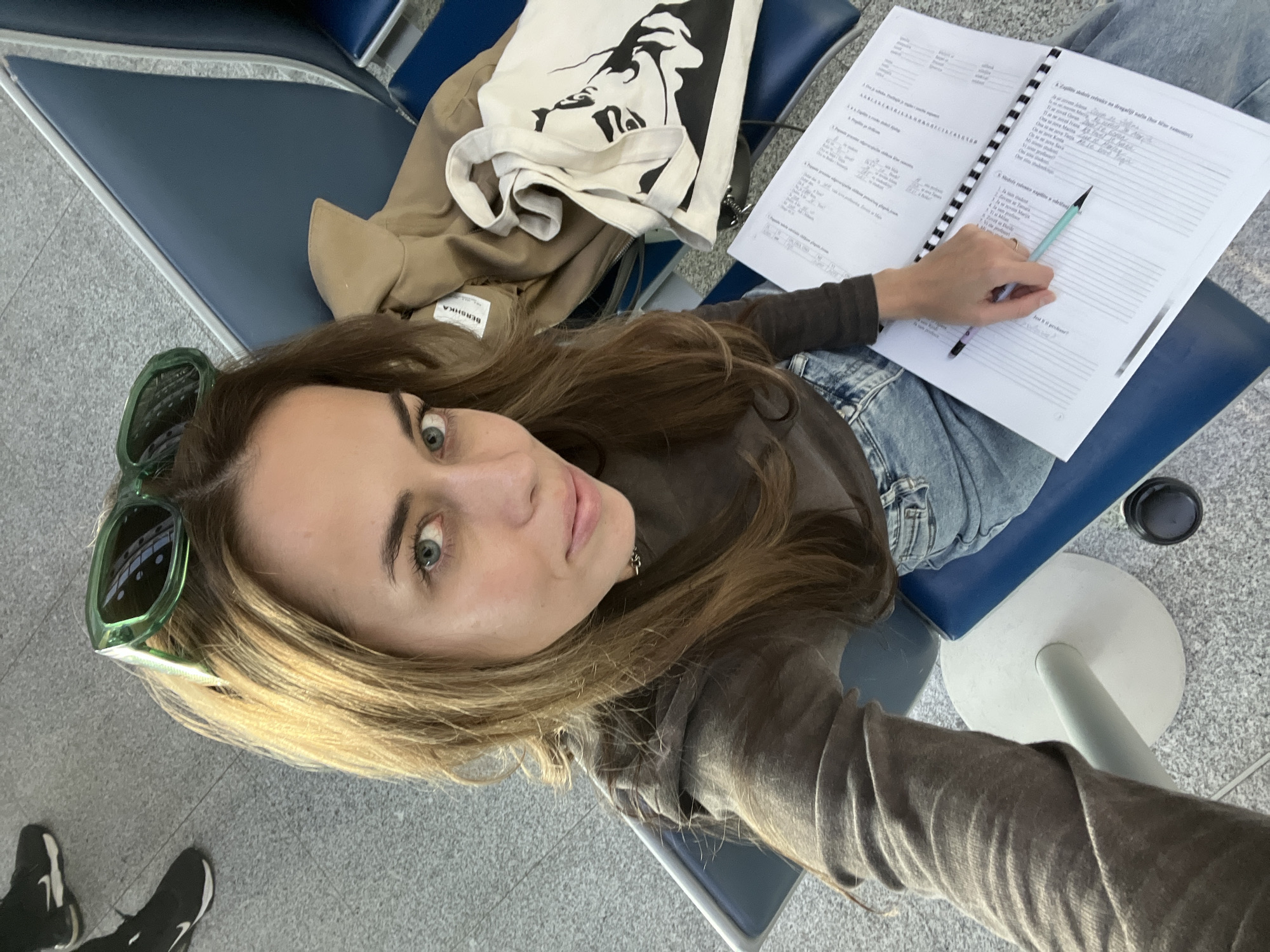 Woman studies Serbian at Montenegro airport awaiting mother reunion