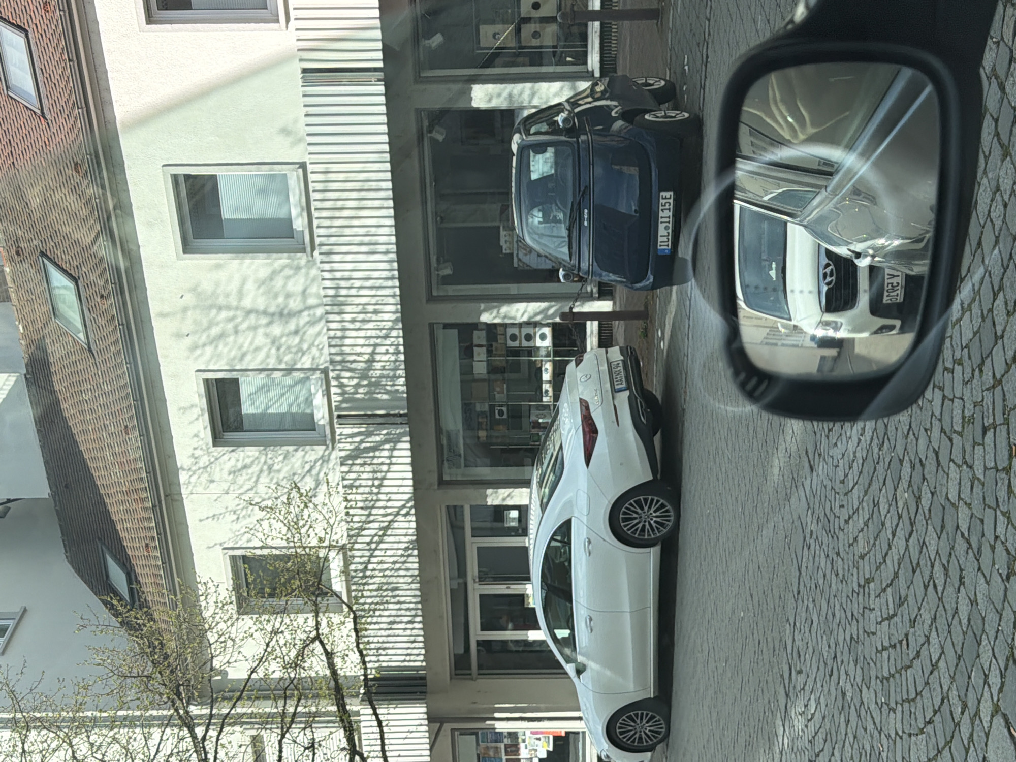 White Mercedes CLA spotted parked on Ulm cobblestone street