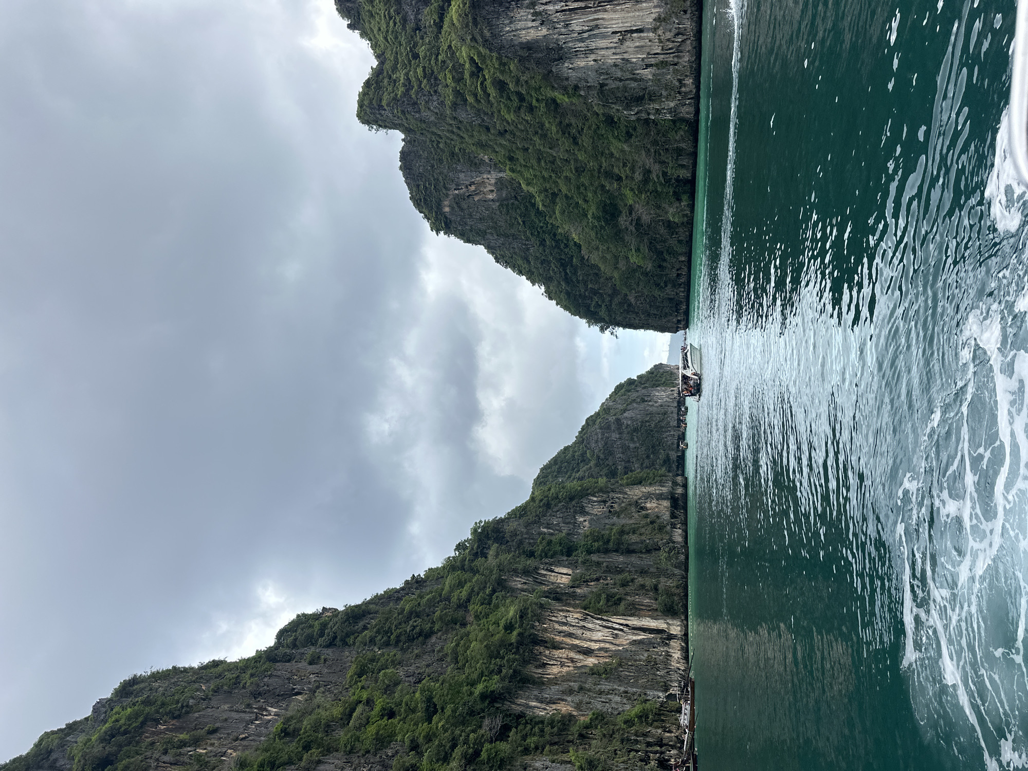 Limestone bay in Haad Yao with longtail boats and clear turquoise water