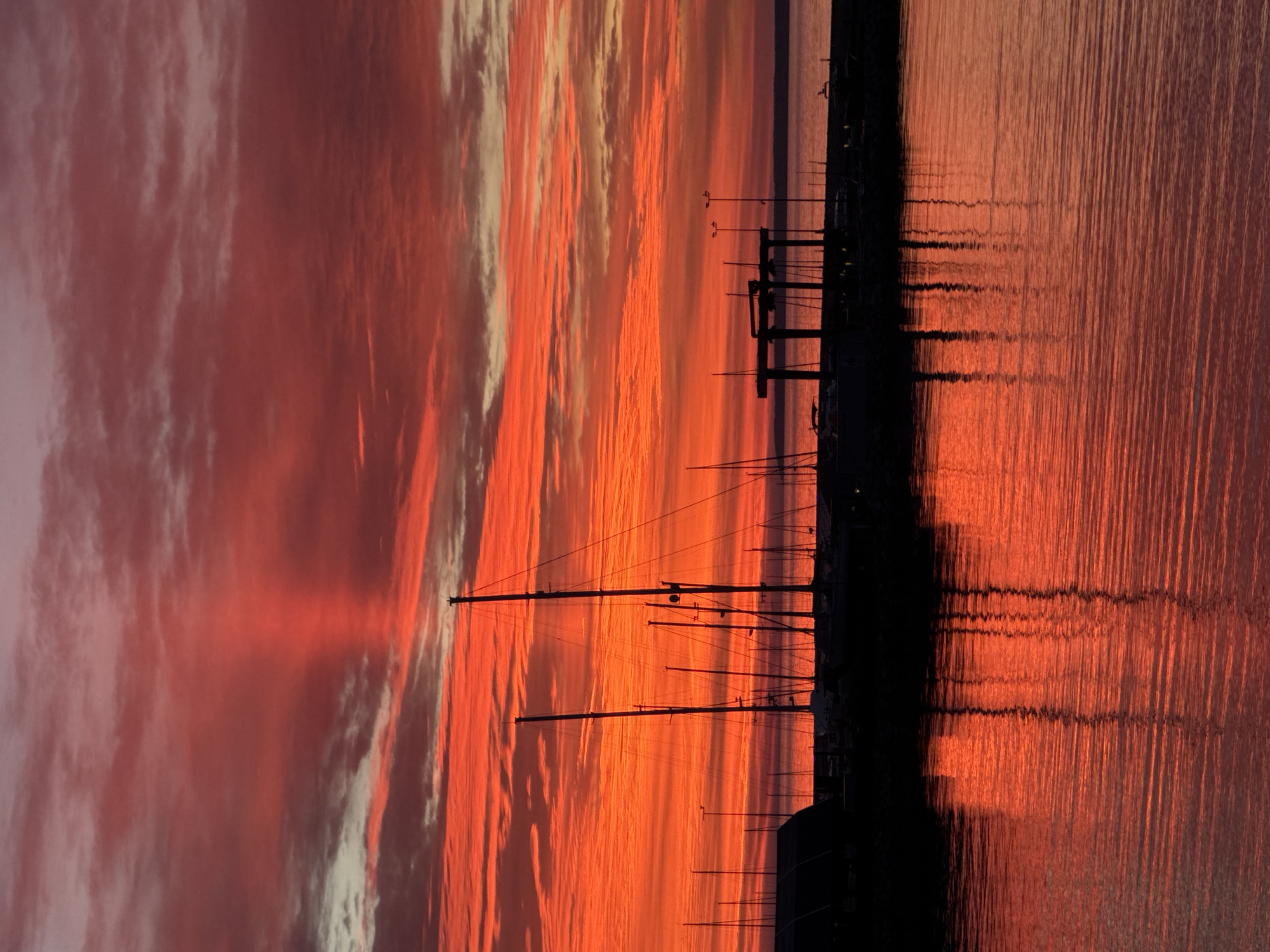 Dramatic sunset illuminates Tallinn's Baltic coastline and marina