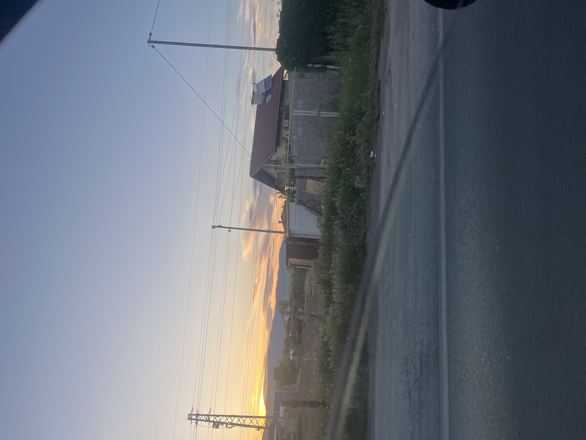 Sunset documented on Blagoevgrad street with cars and power lines