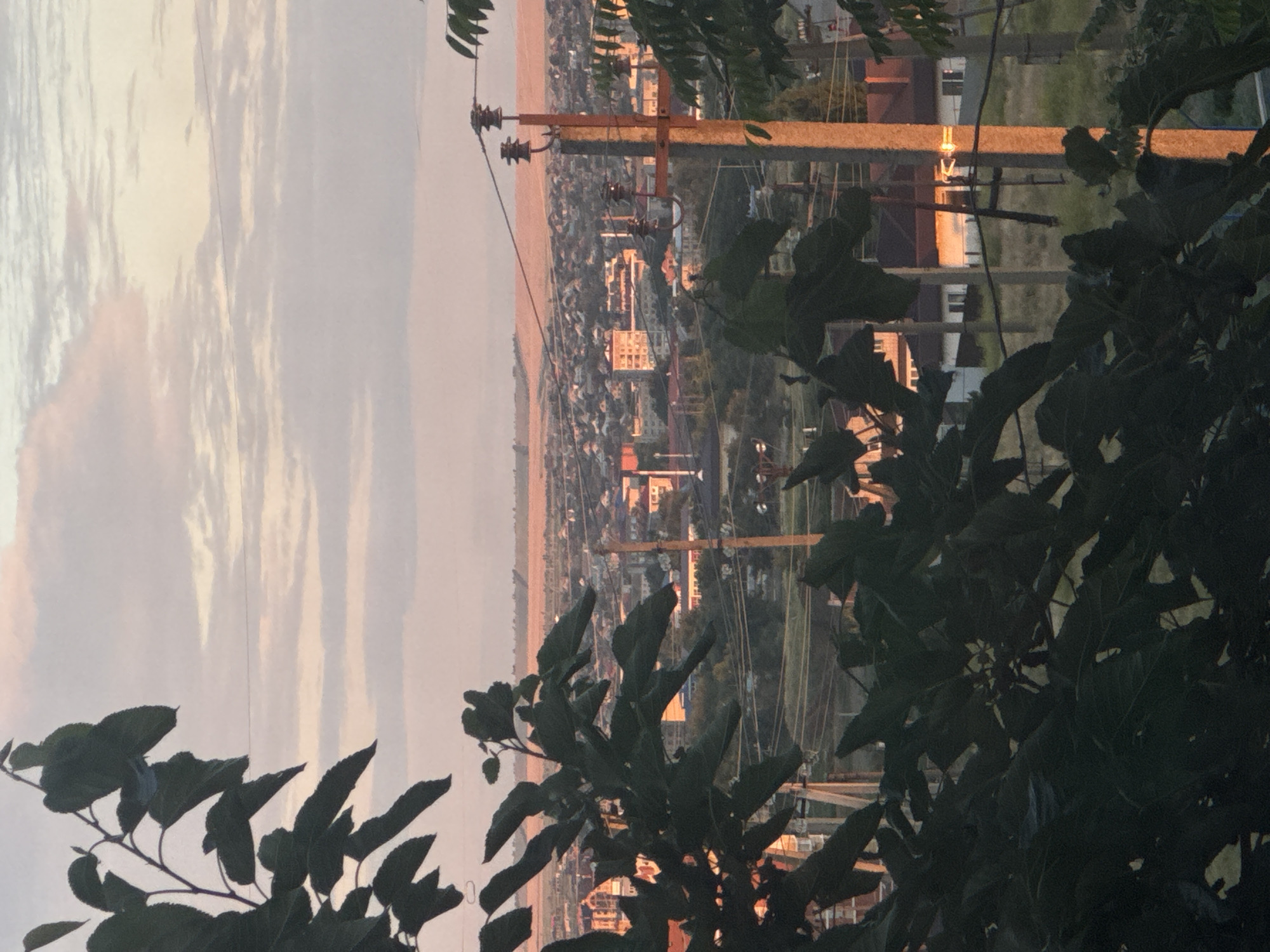 Dusk settles over a city in warm golden light