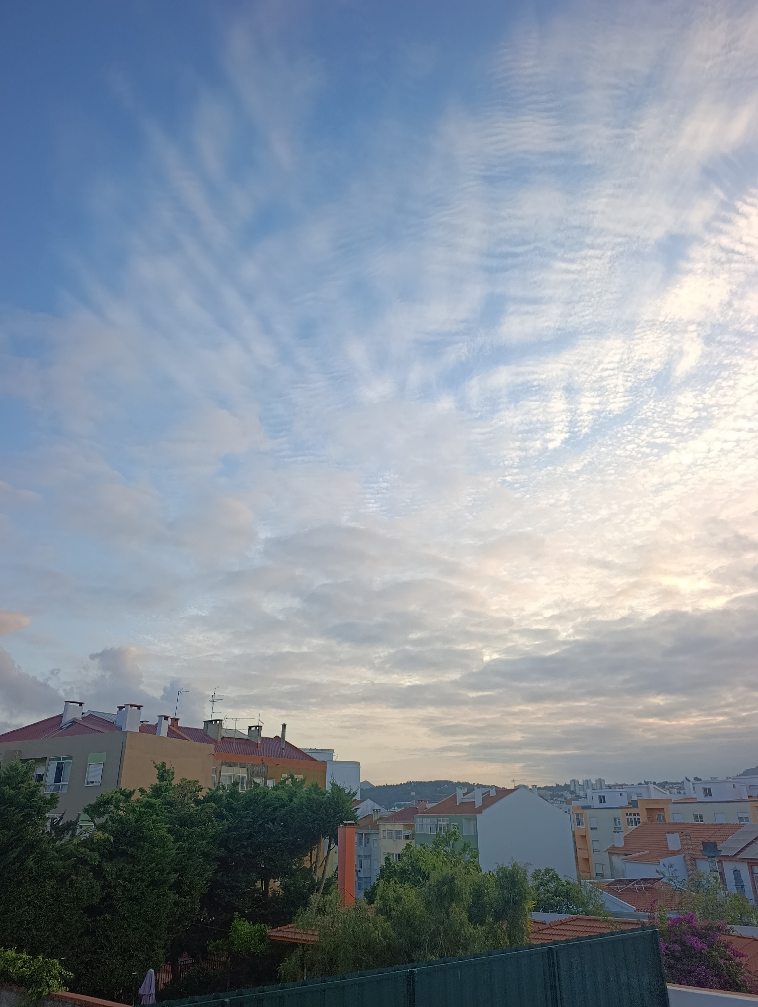 Evening rooftop views over Setúbal under a dramatic sky