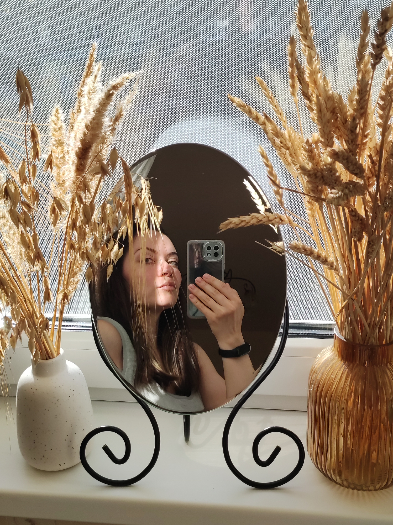 Woman takes mirror selfie on windowsill in Chaikovsky, Russia