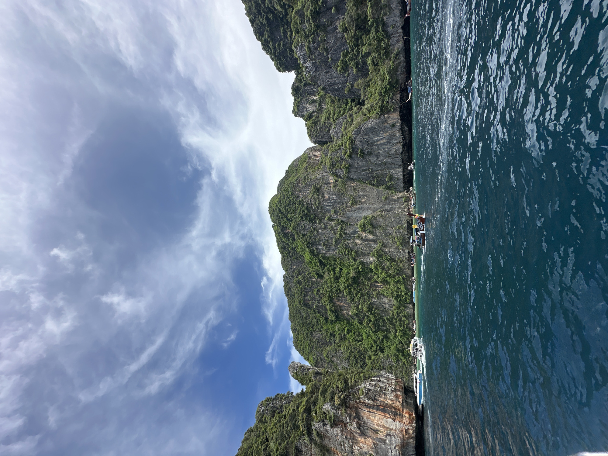 Boats and karst cliffs at Haad Yao, southern Thailand