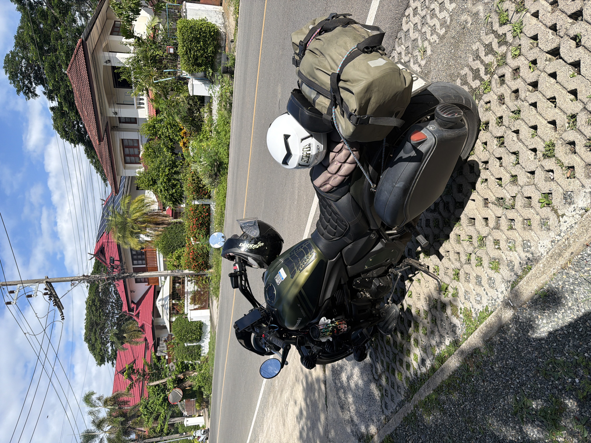 Morning cafe stop in Chang Phueak with a loaded touring motorcycle outside
