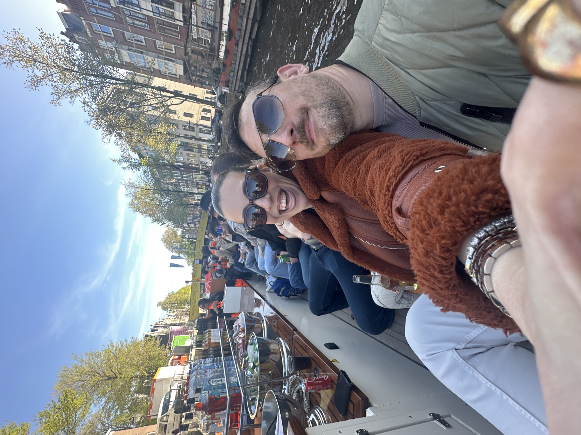Canal boat tours operate in sunny Amsterdam afternoon
