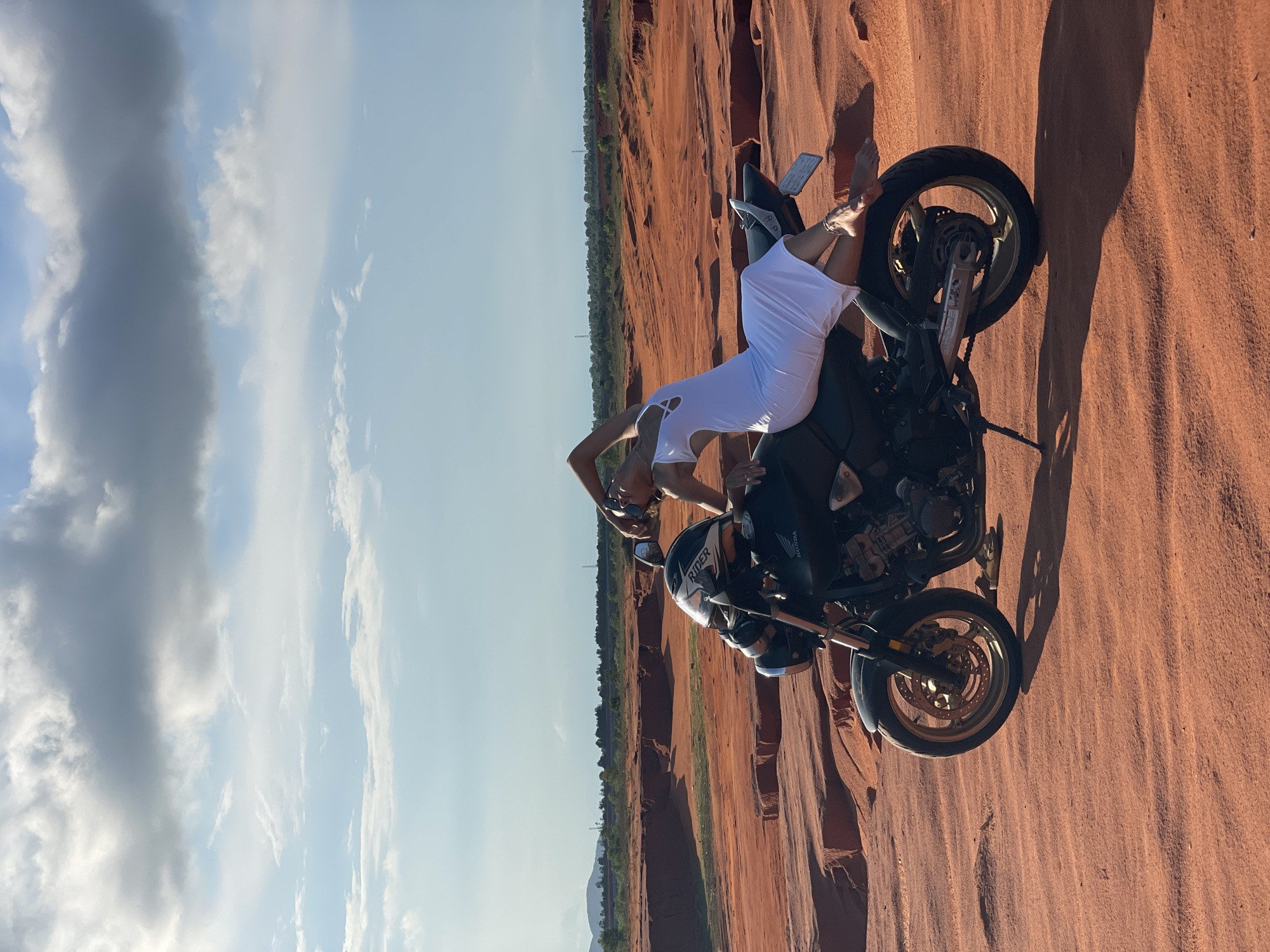 Woman poses with motorcycle in Mui Ne sand dunes