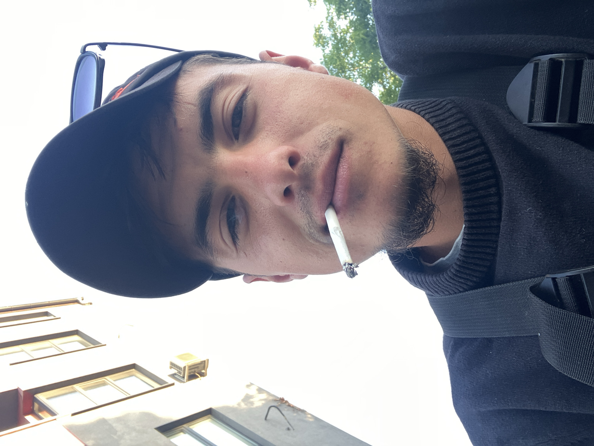 Young man photographed smoking on rainy Plovdiv streets