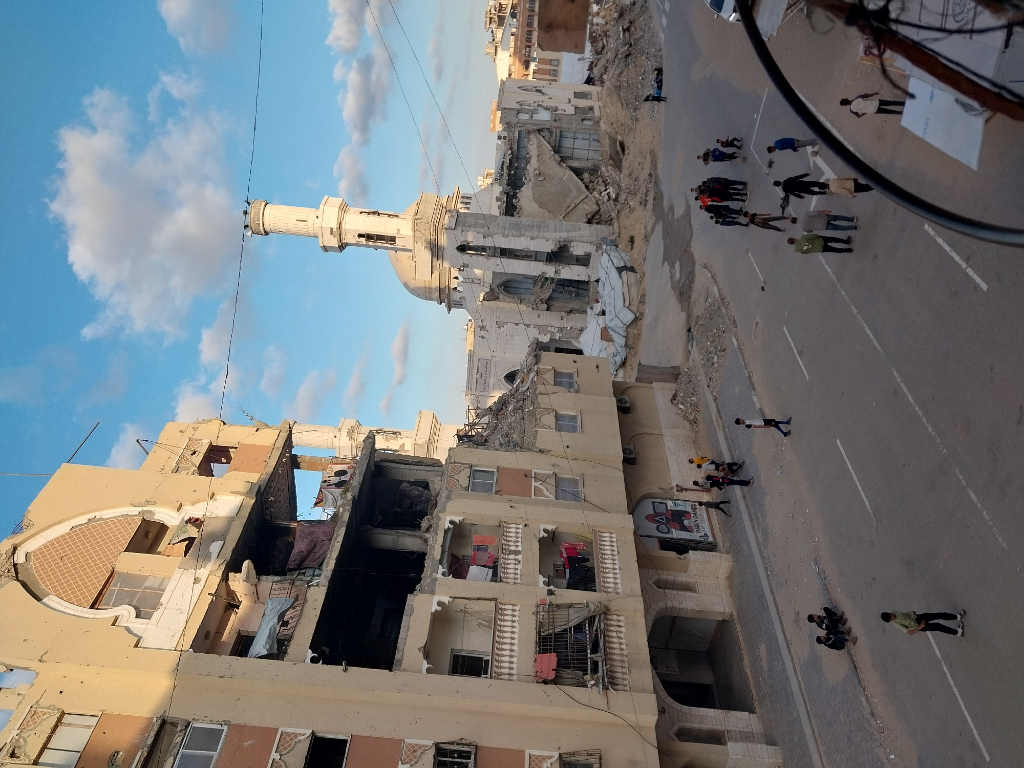 Street scene shows damaged buildings, mosque in Khan Yunis