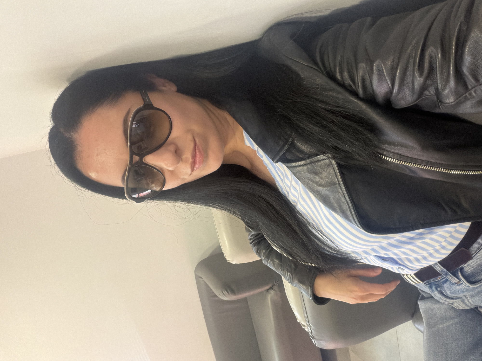 Woman in leather jacket and striped shirt spotted