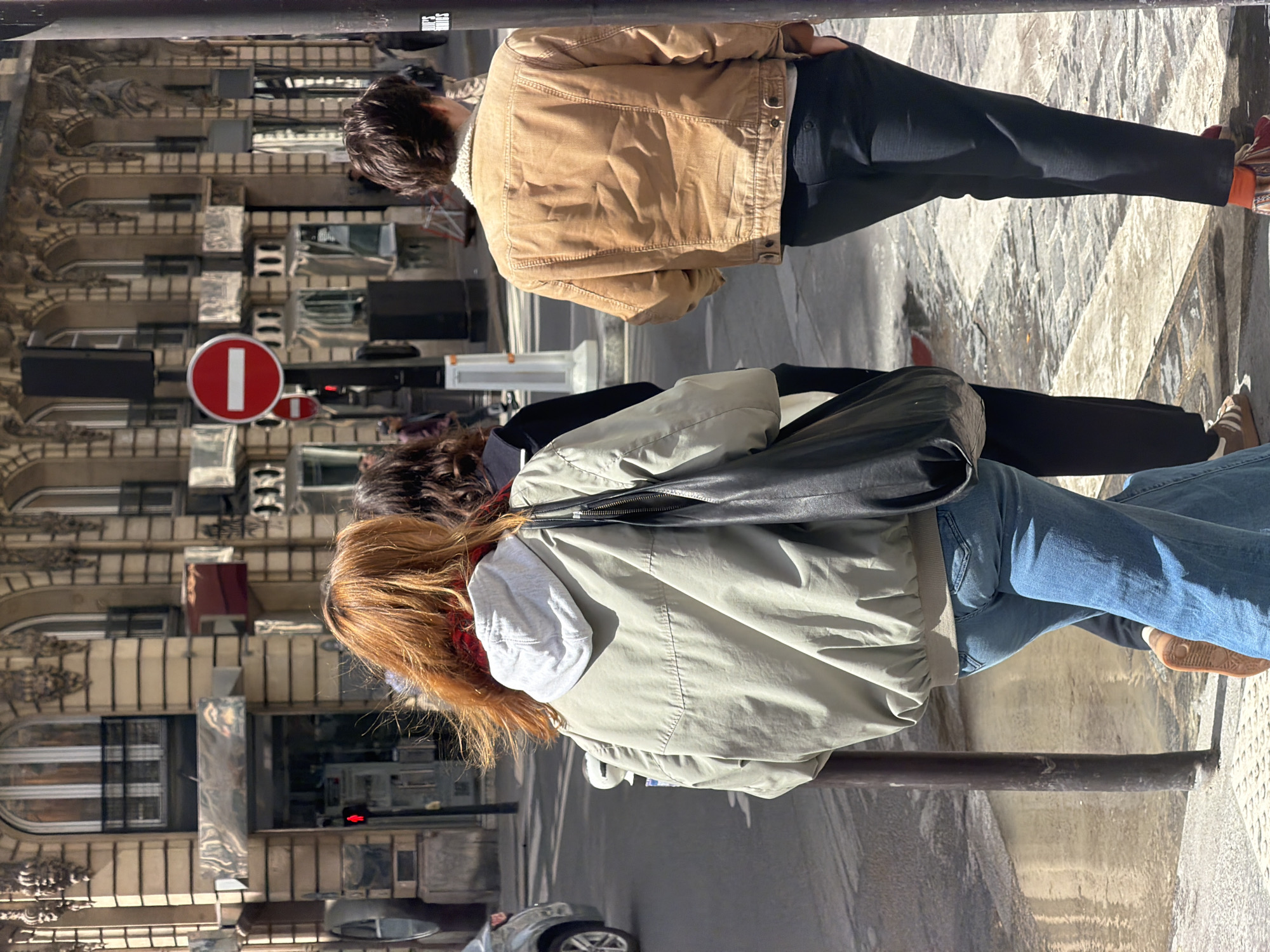 Ordinary street life observed in sunny Paris neighborhood
