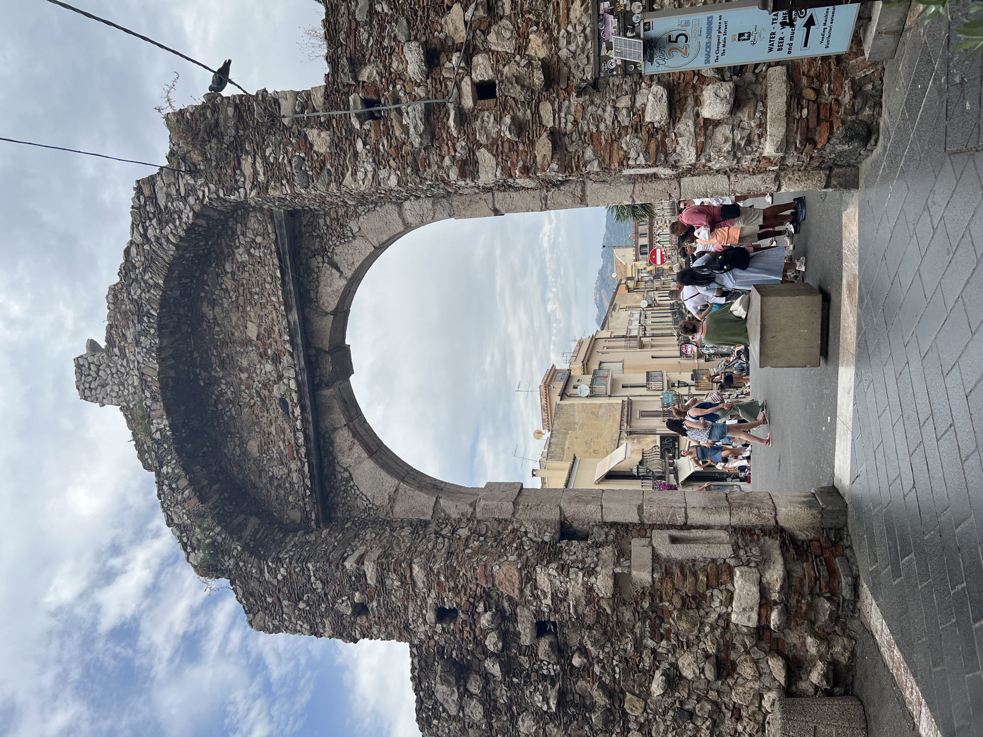 Morning stroll through Taormina's streets, archways, and hillside views