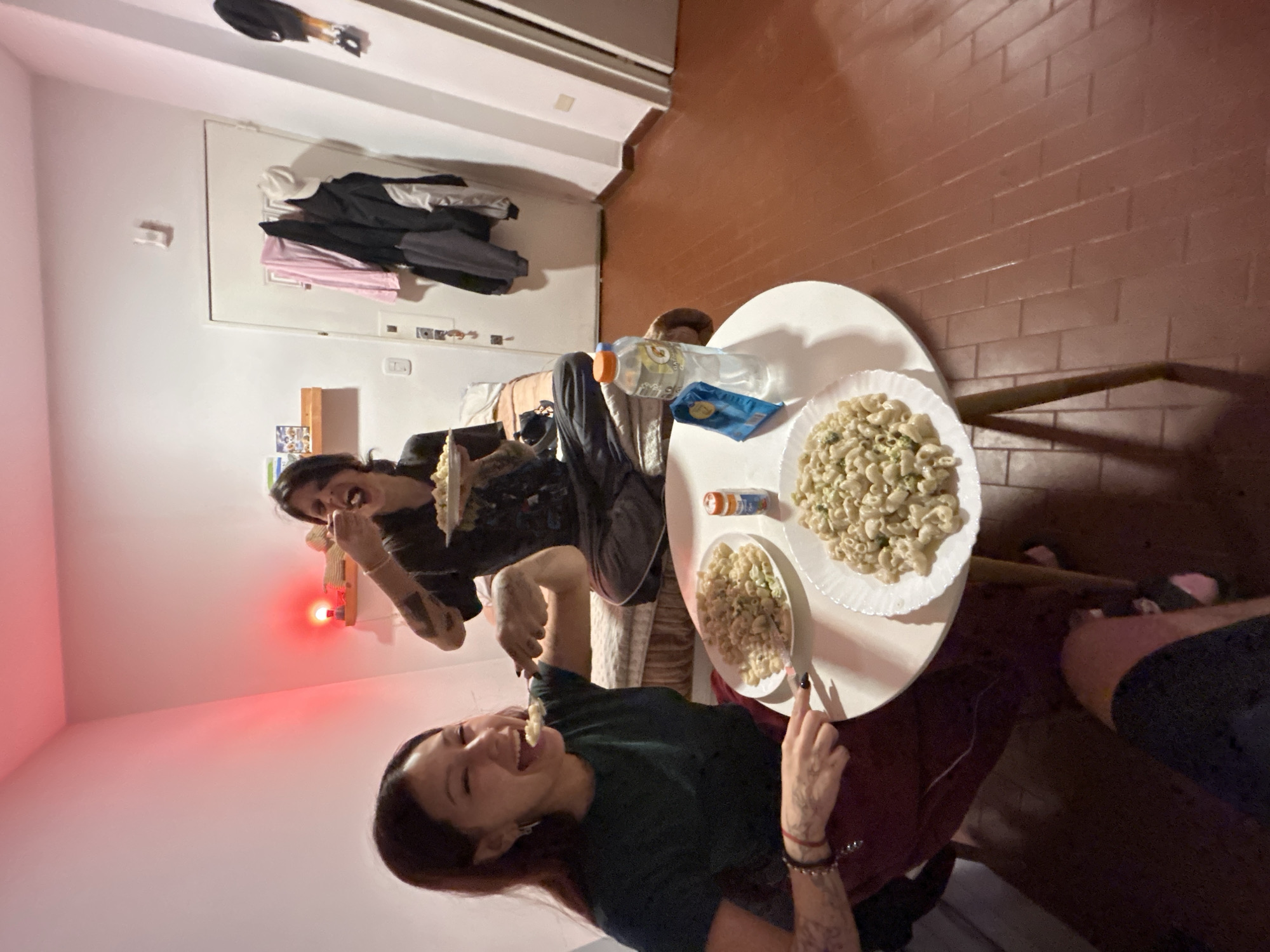 Two women share pasta dinner at Buenos Aires home