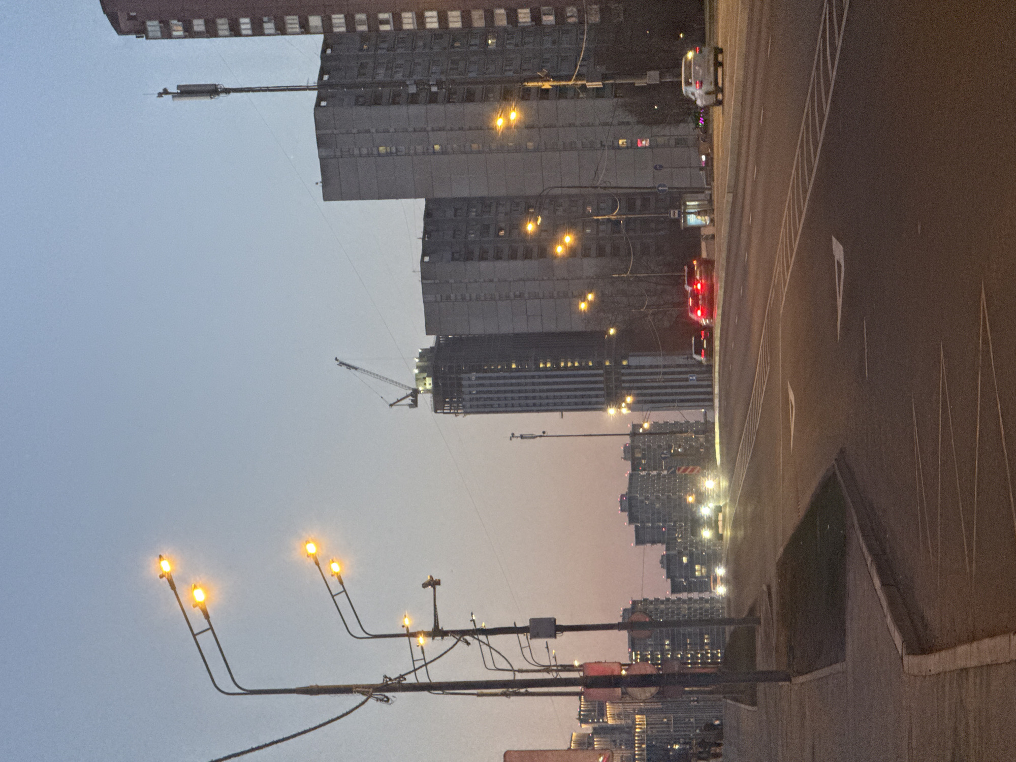Moscow apartment buildings and construction cranes at dusk