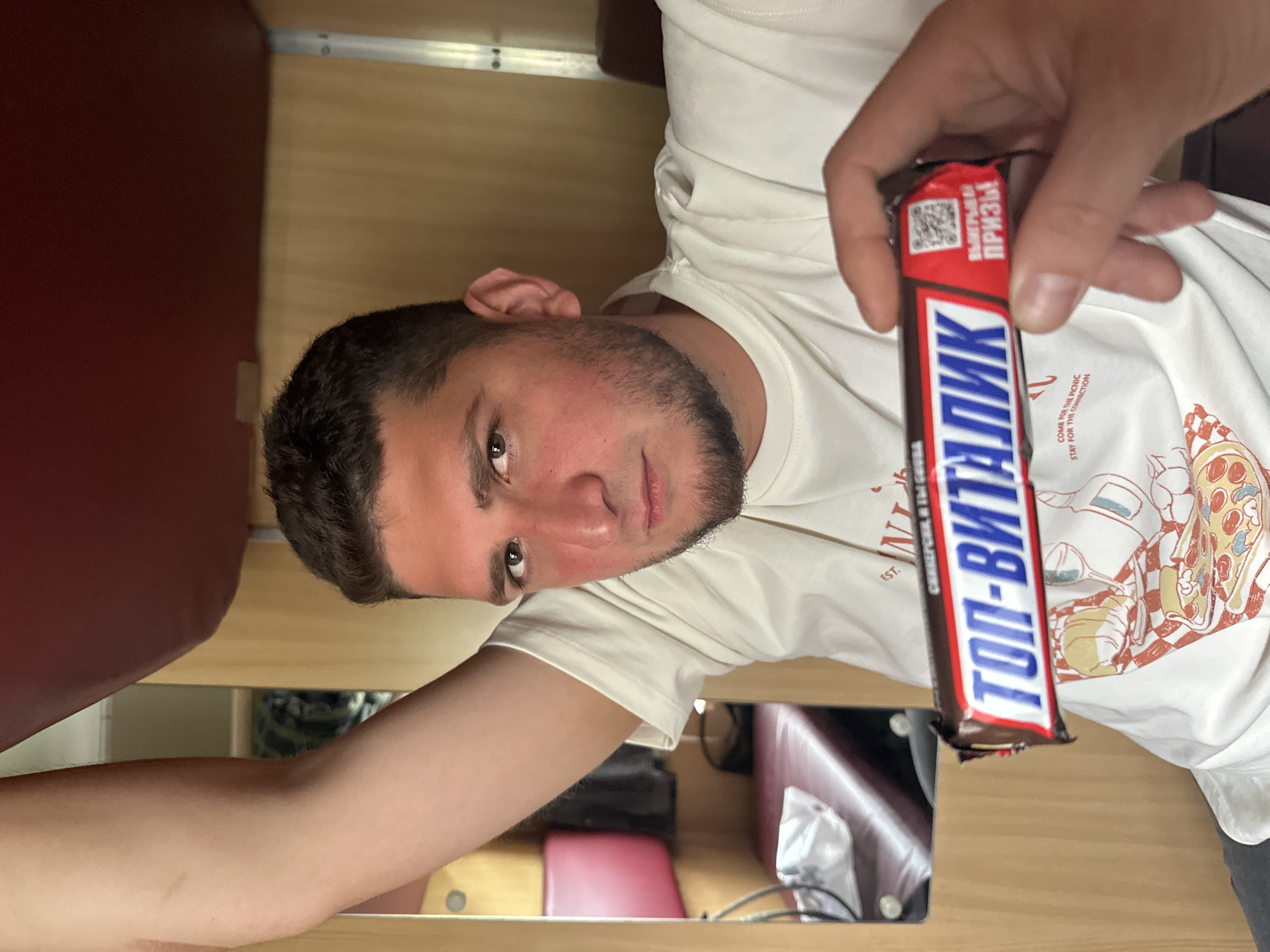 Passenger enjoys chocolate bar on morning train in Belarus