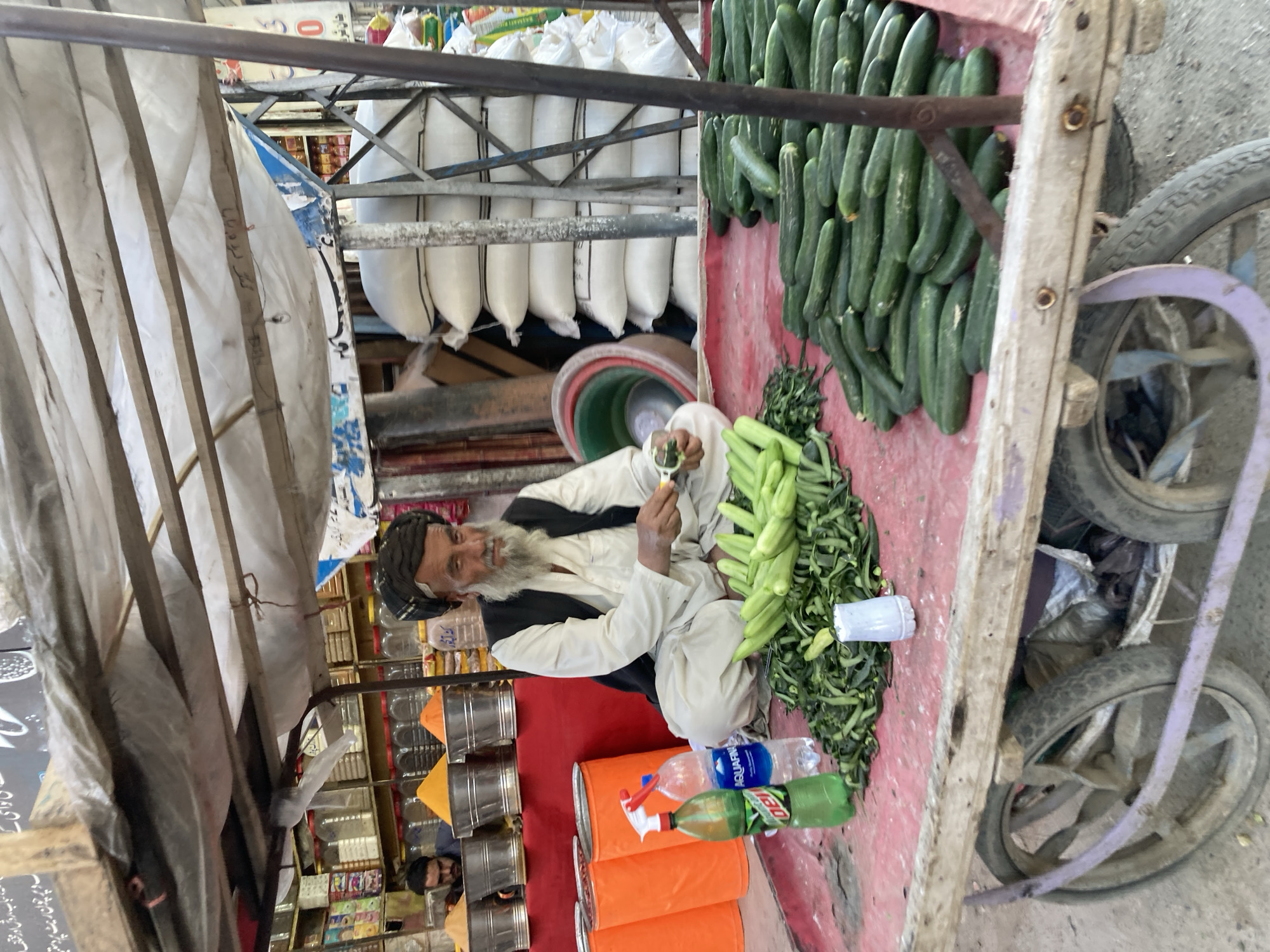 Traditional vendor prepares produce on street cart in Quetta