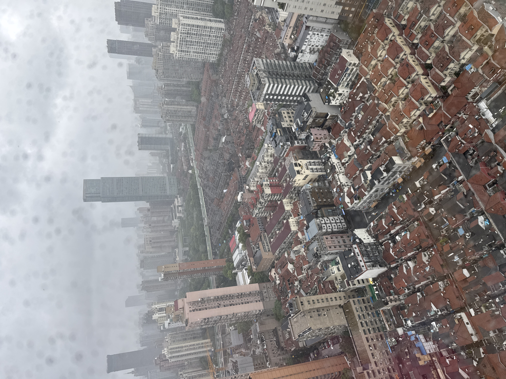 Rainy-day Shanghai skyline, shot from a high-rise window
