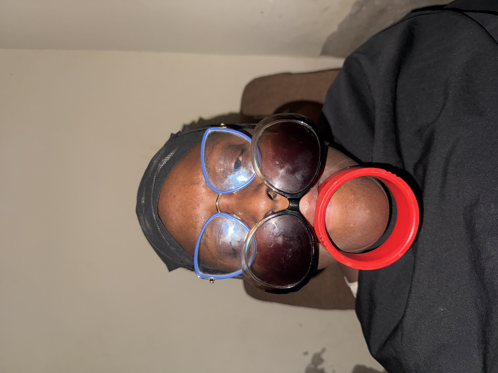 Person in Yelwa photographed wearing multiple pairs of glasses