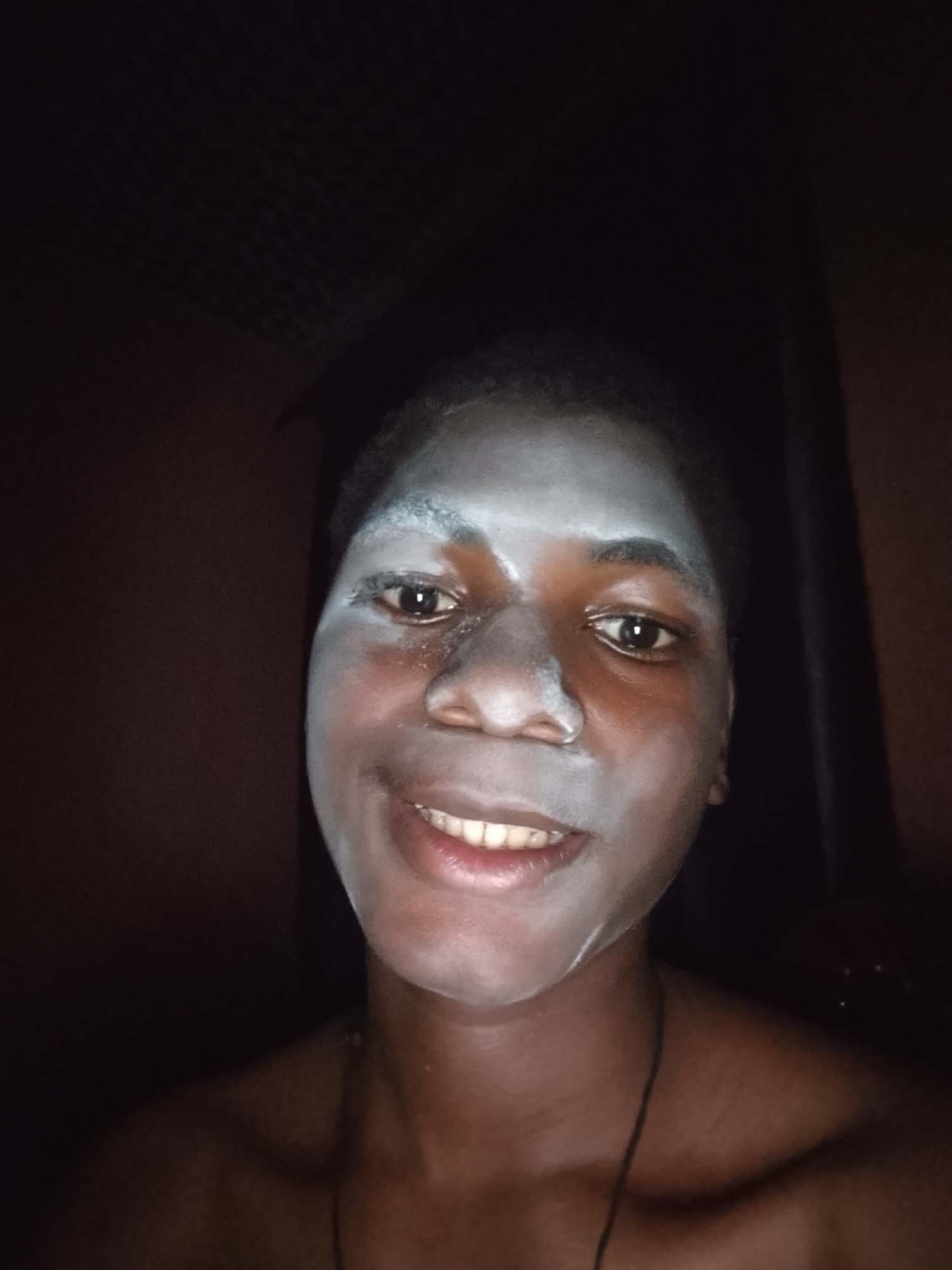 Person photographed smiling with white face application