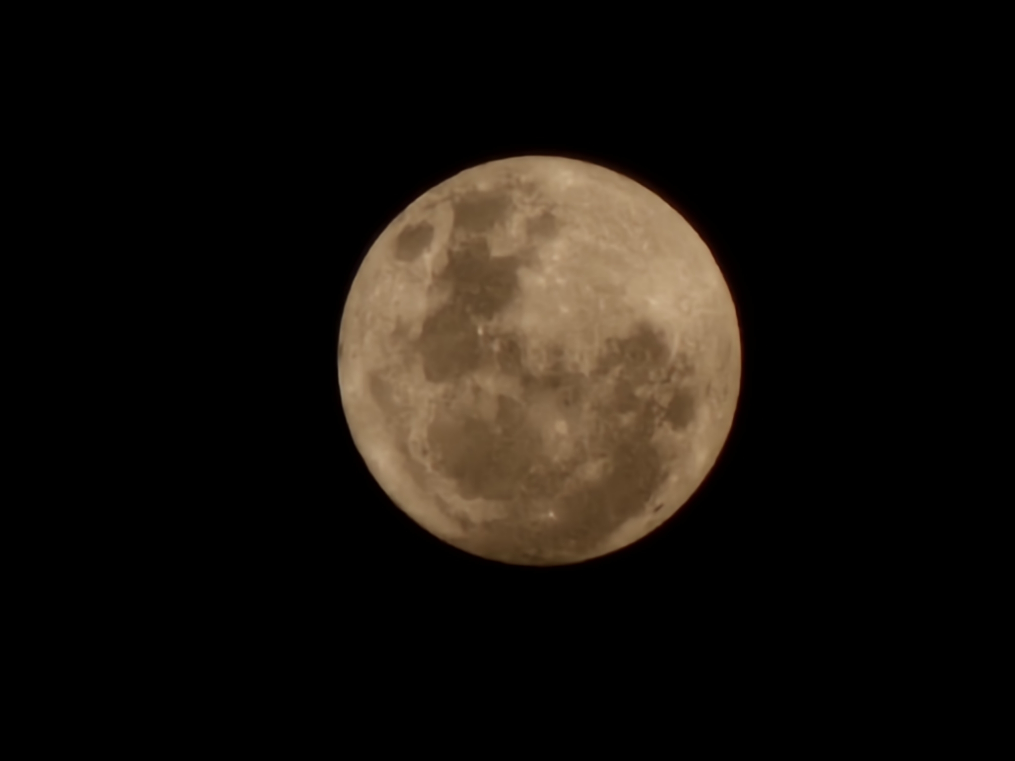 Brownish-orange full moon rises over Burgas, Bulgaria
