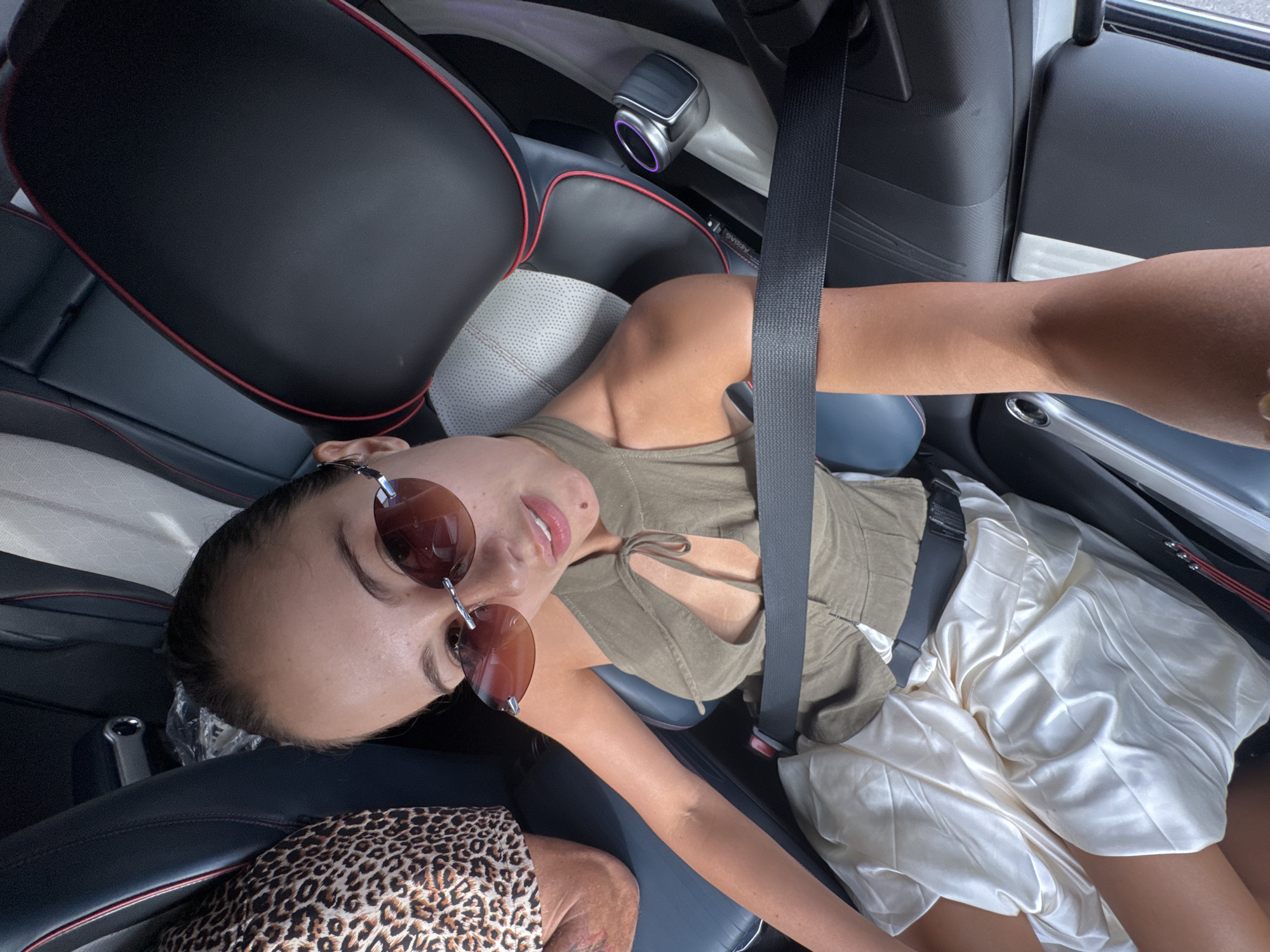 Woman in sunglasses relaxes in car in Khok Kloi