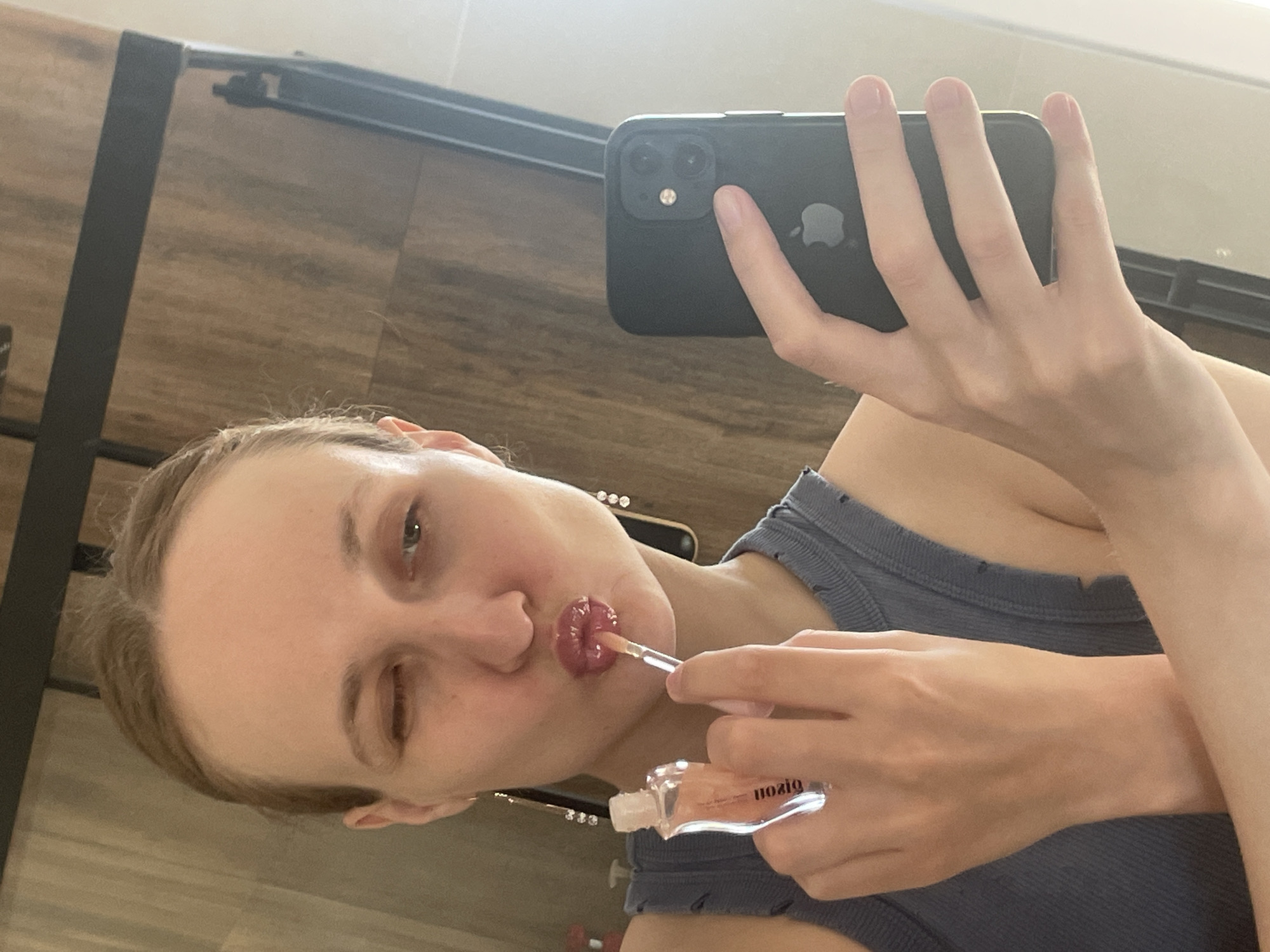 Woman Takes Selfie While Applying Lip Gloss in Russia