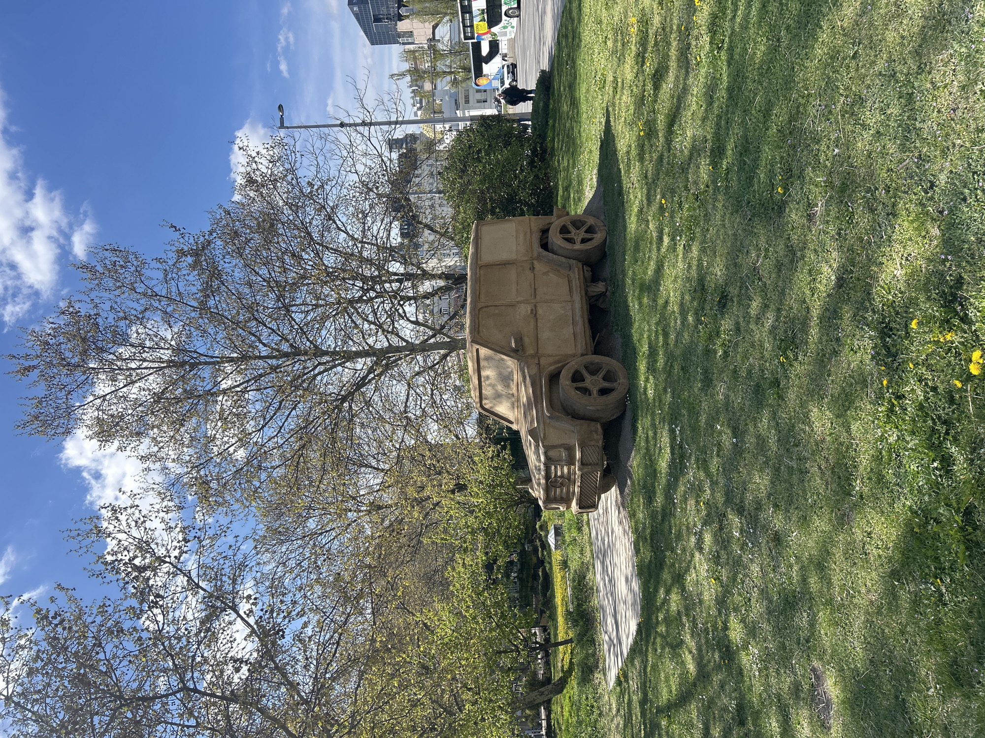 Concrete military jeep sculpture spotted on Vienna pathway