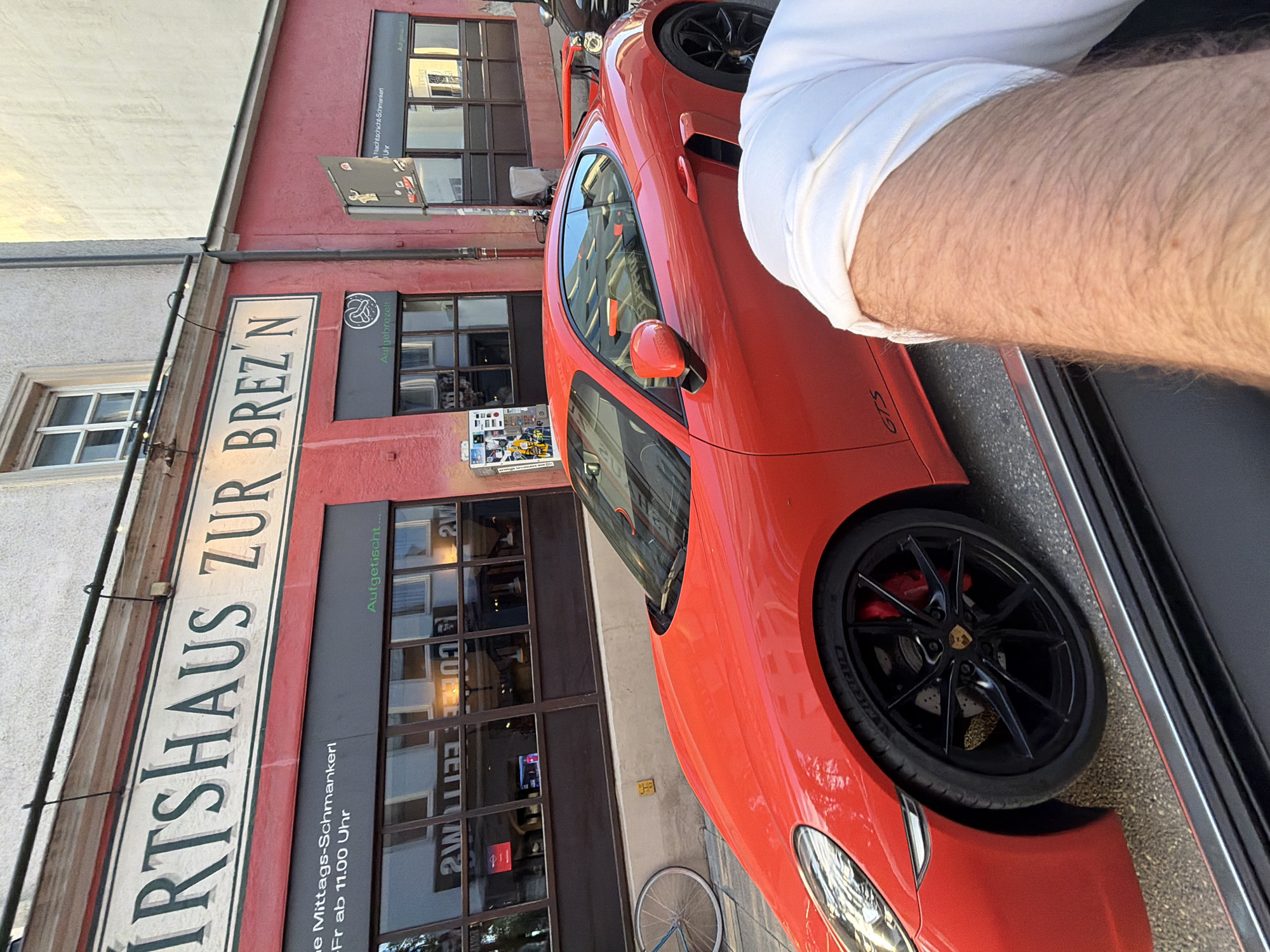 Red Porsche, local shops, and Munich streets on a summer evening