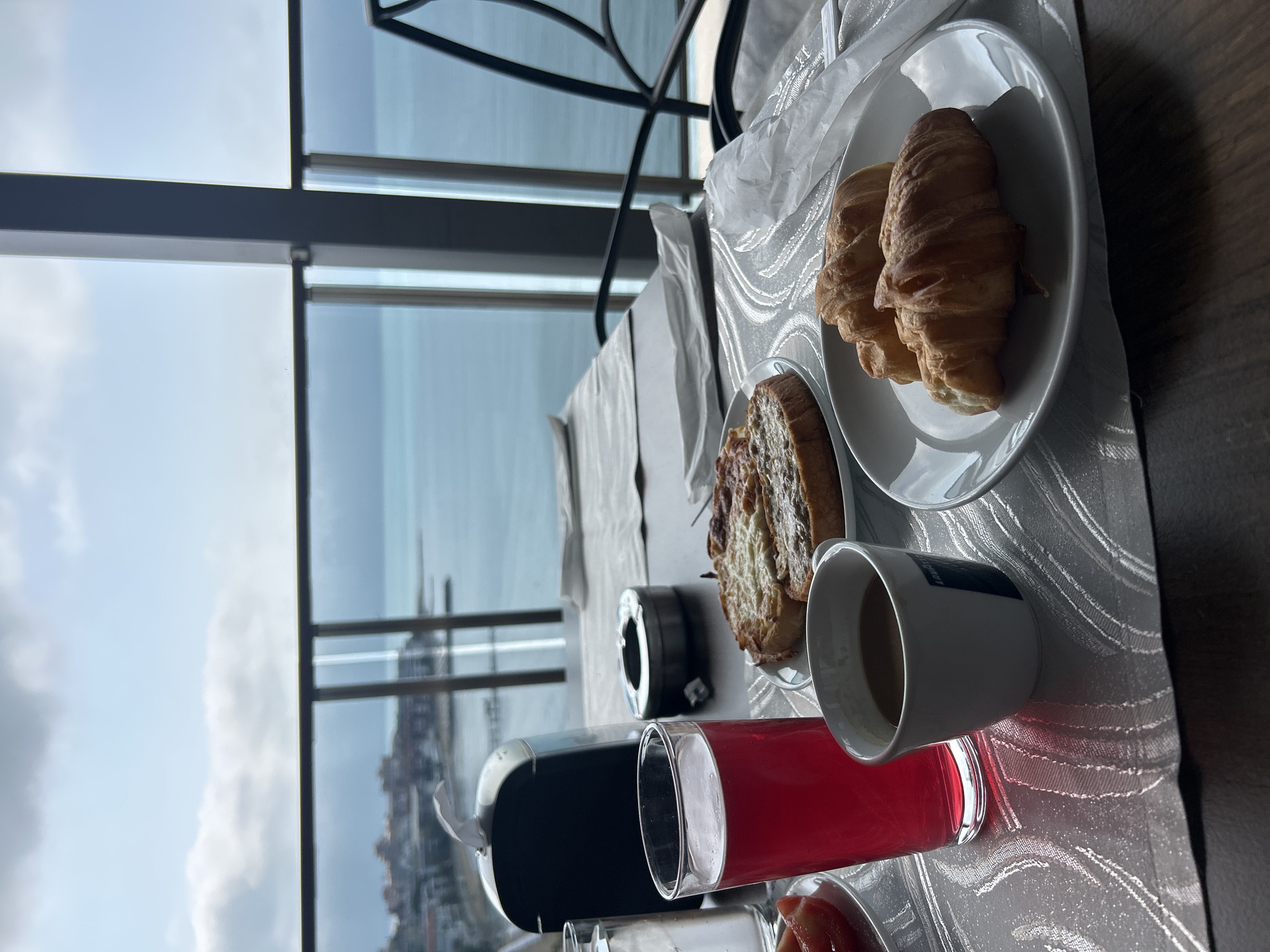 Morning breakfast setup captured with seaside panoramic view