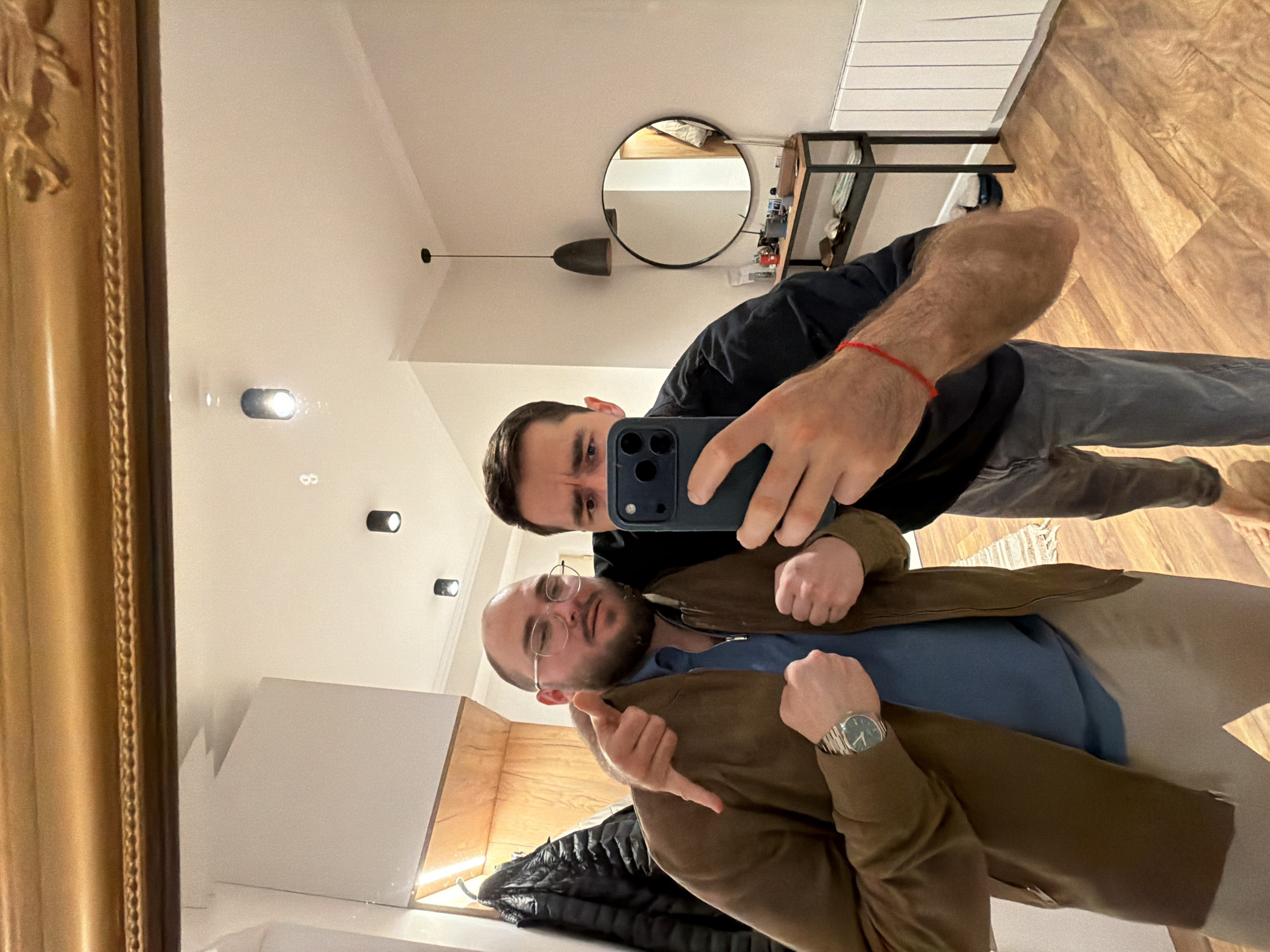 Two men take mirror selfie in Tbilisi