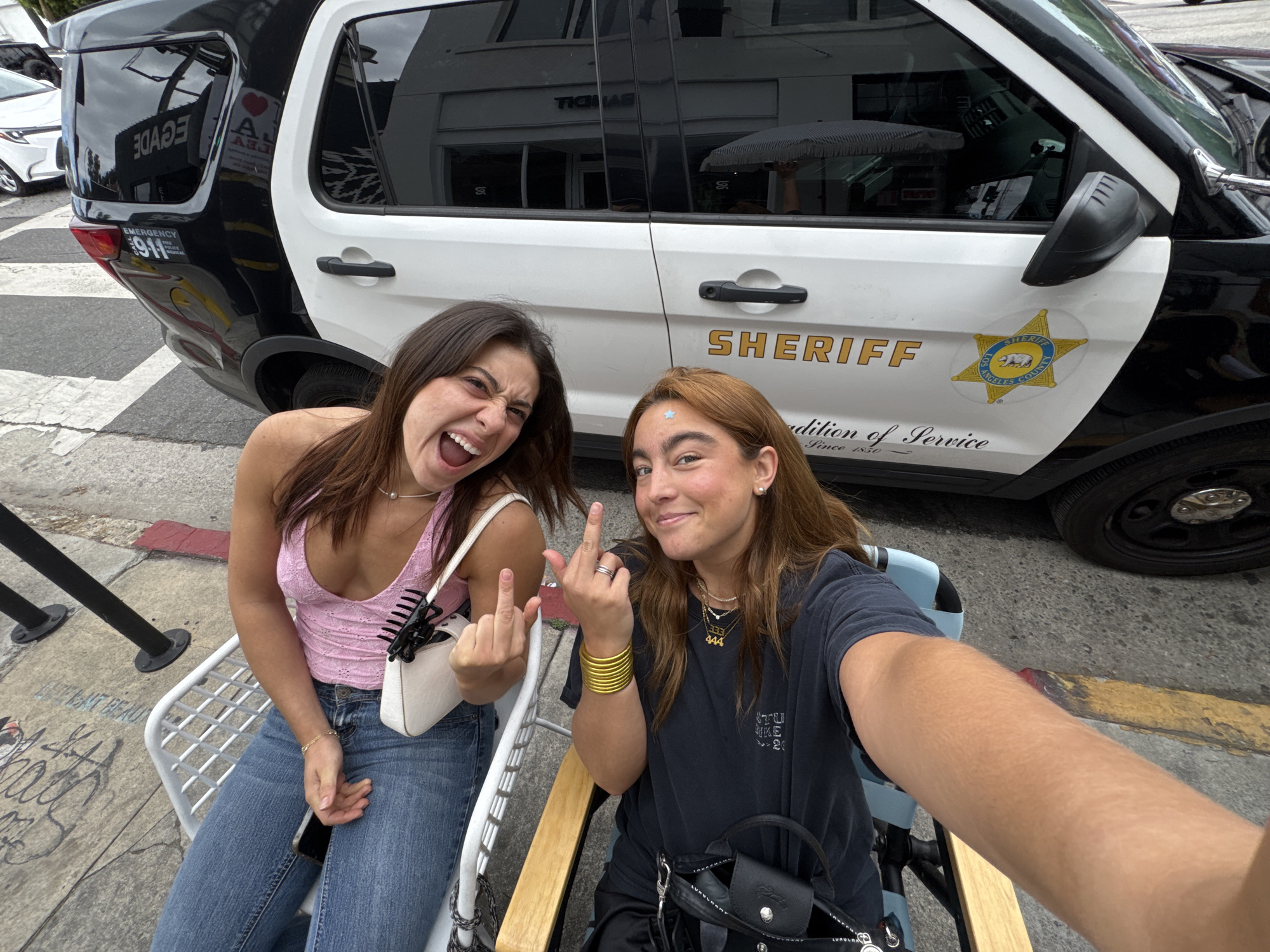 Woman grimaces at outdoor table in Los Angeles