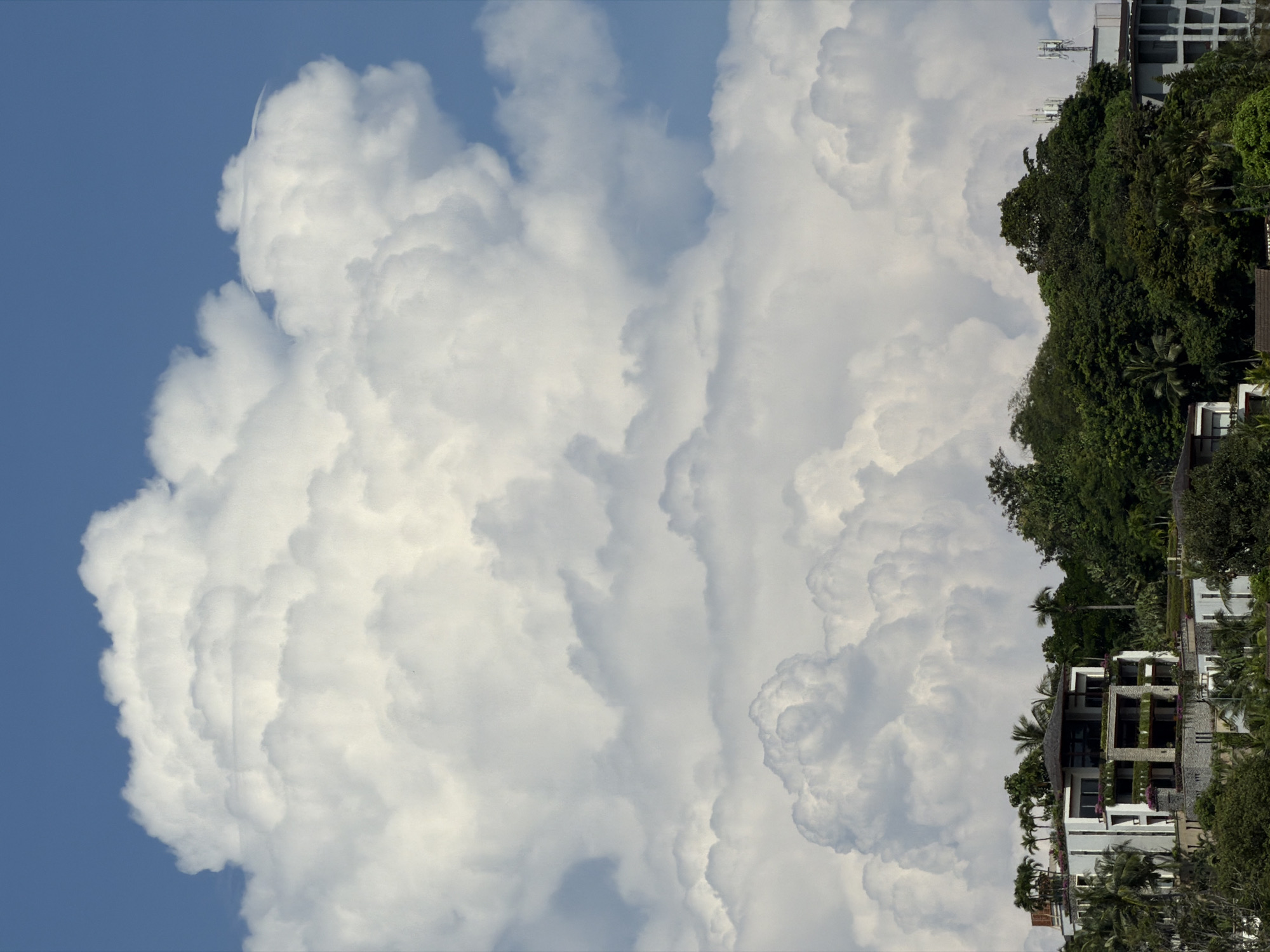 Speedboat on calm water as storm clouds build over hillside