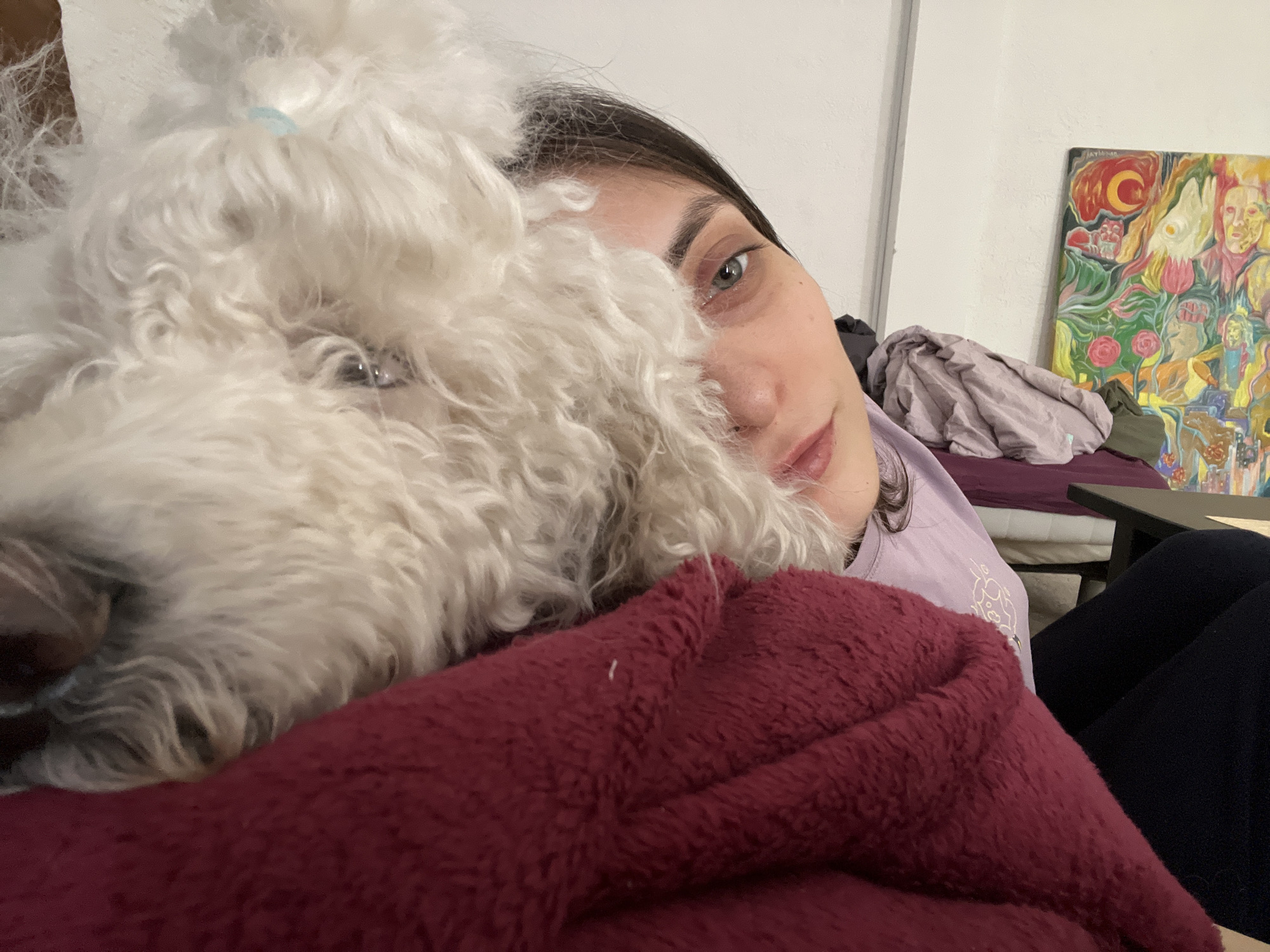Woman takes selfie with white fluffy dog in Krasnoyarsk