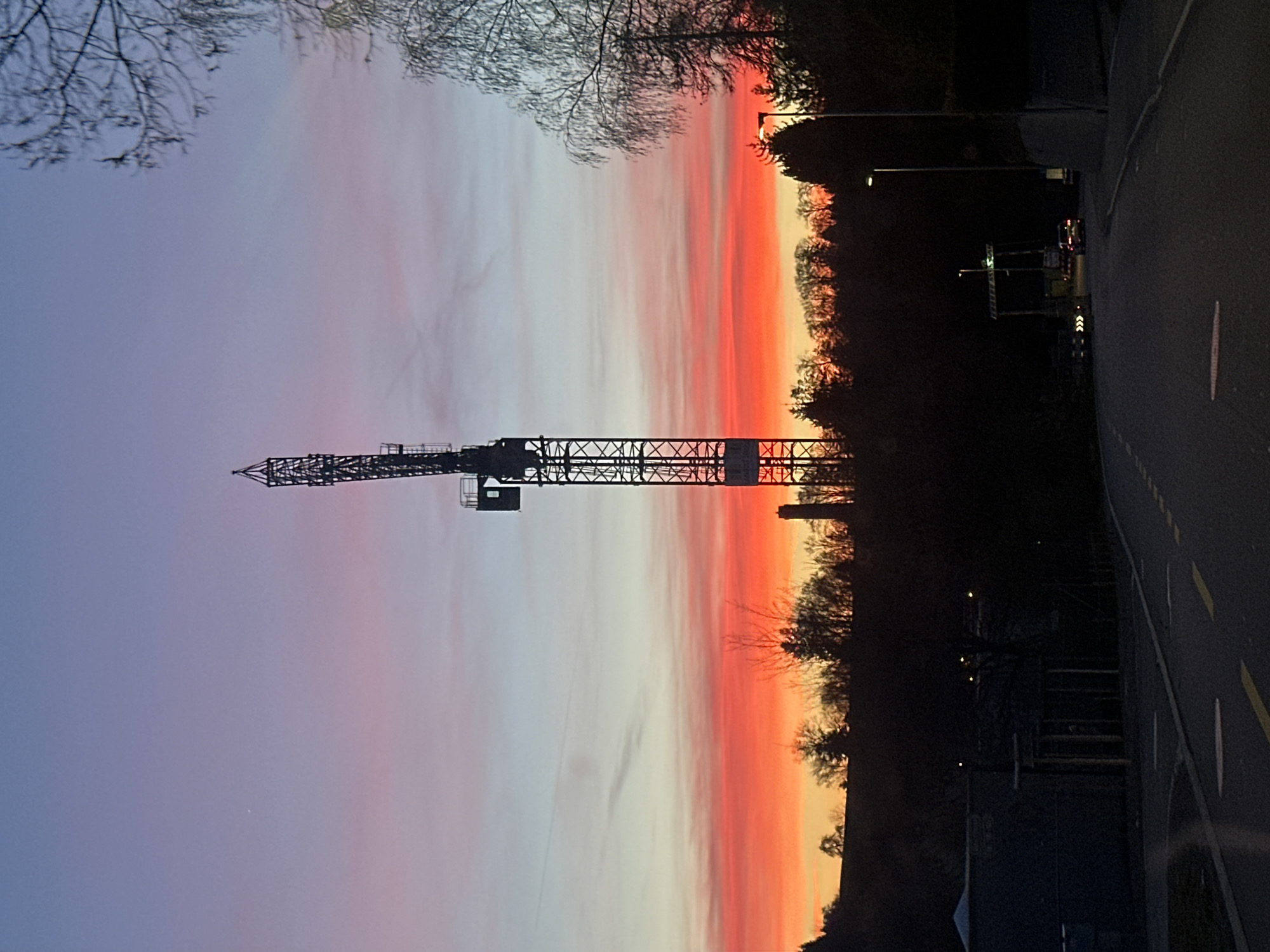 Sunset illuminates construction crane in Wetzikon, Switzerland
