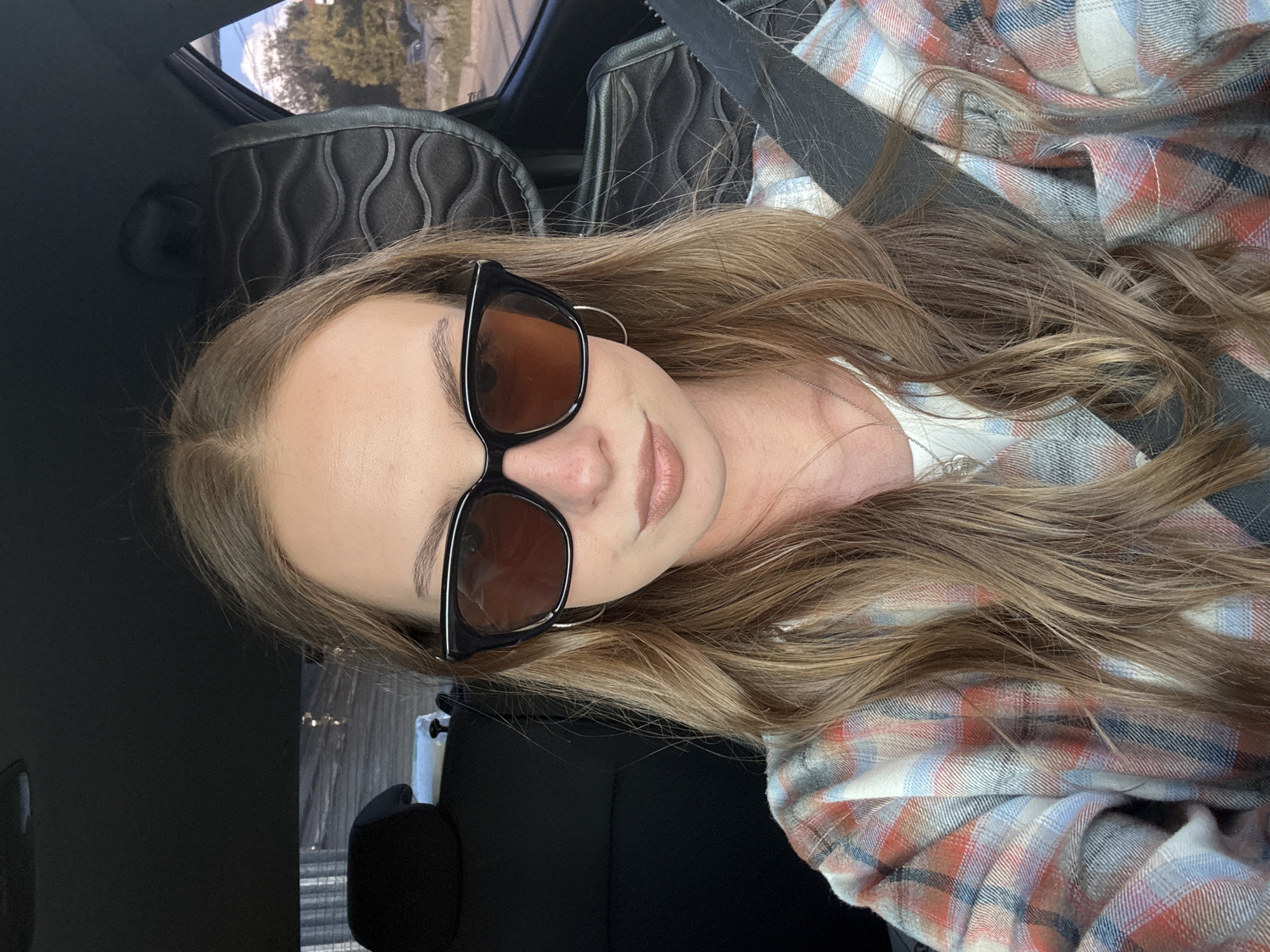 Woman takes car selfies near industrial area in Perm